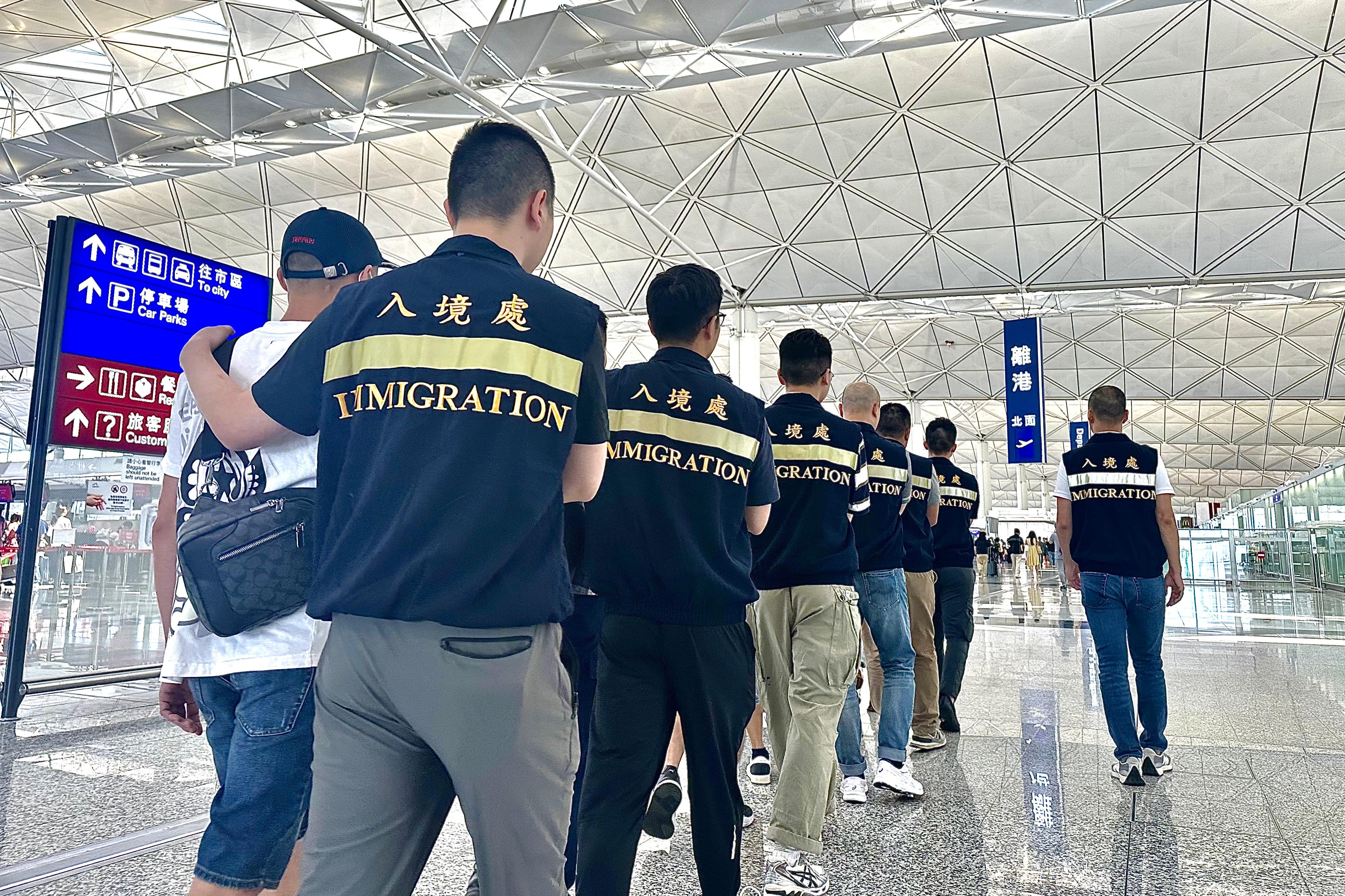 入境事務處（入境處）今日（九月二十八日）執行遣送行動，將23名越南籍非法入境者遣返越南。圖示被遣返人士在入境處人員押送下離港。