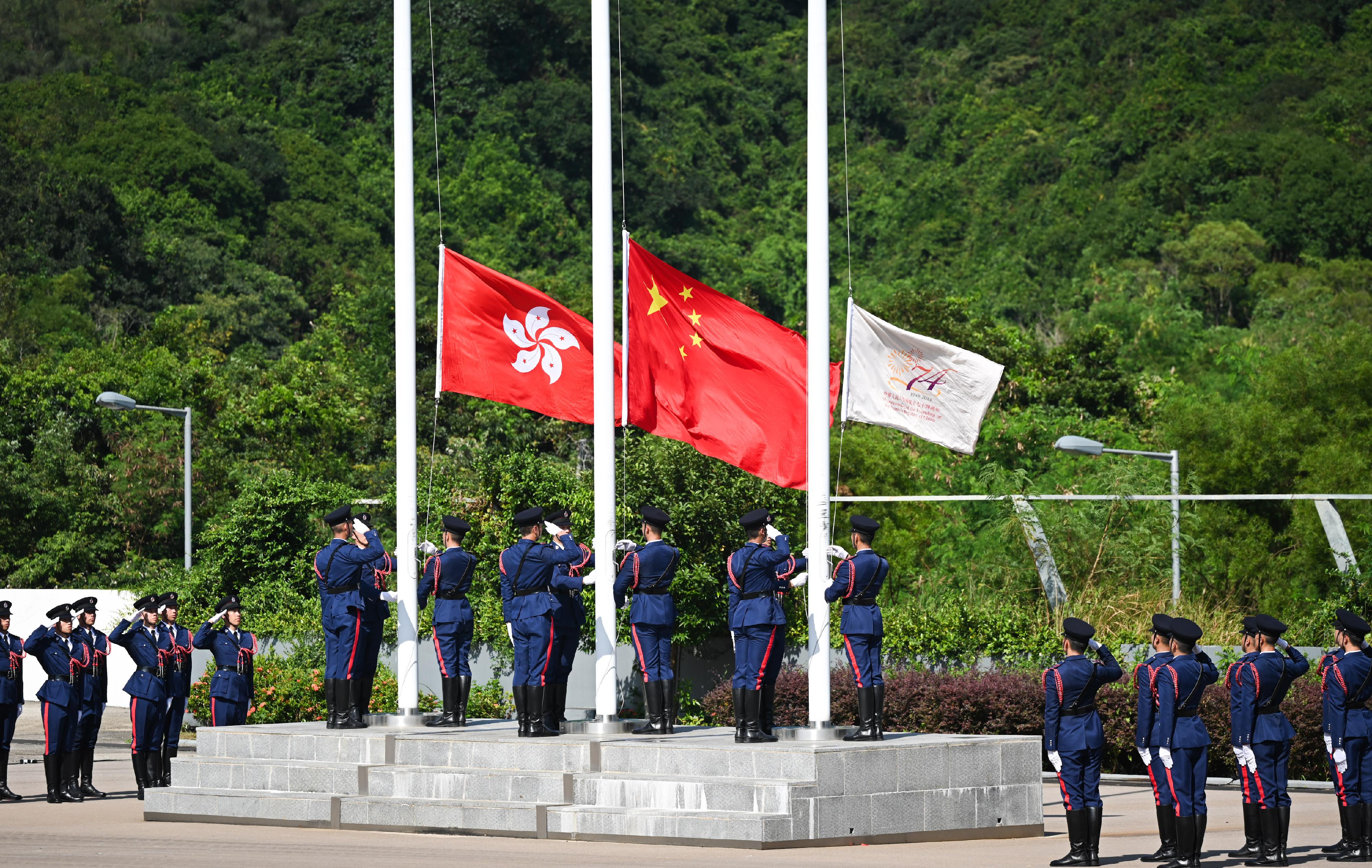 The Security Bureau led its disciplined services and auxiliary services, together with youth uniformed groups, to hold the Parade by Disciplined Services and Youth Groups cum Carnival for Celebrating the 74th Anniversary of the Founding of the People's Republic of China at the Fire and Ambulance Services Academy in Tseung Kwan O today (October 1) to celebrate the National Day with members of the public. Photo shows the Fire Services Department flag party conducting a flag-raising ceremony.
