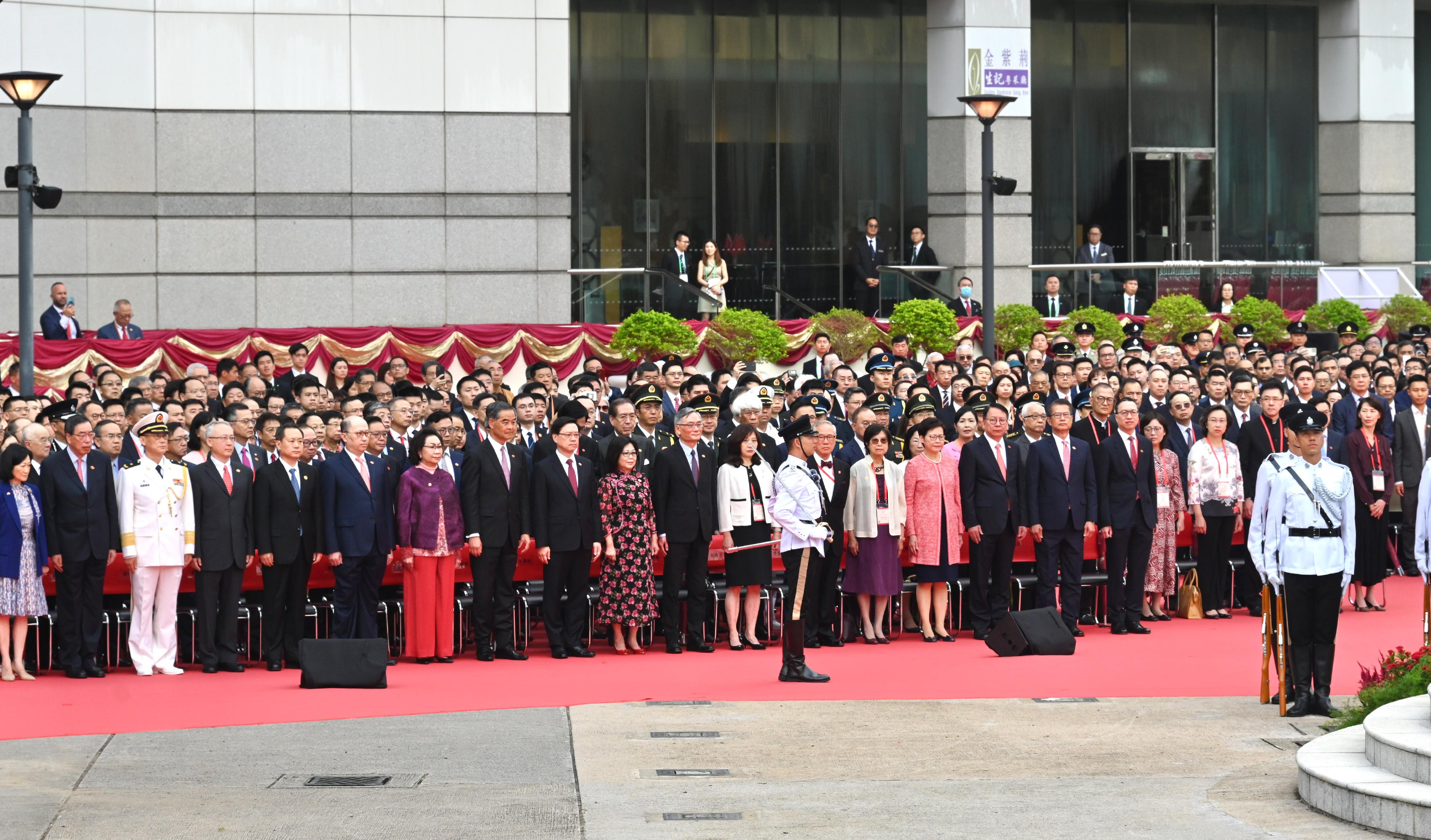 The Chief Executive, Mr John Lee(front row, 9th left), his wife(front row, 9th right);Chief Justice of the Court of Final Appeal, Mr Andrew Cheung Kui-nung(front row, 8th right), and his wife(front row, 7th right);former CE Mr Donald Tsang(front row, 6th right) and his wife(front row, 5th right);Vice-Chairman of the National Committee of the CPPCC Mr C Y Leung(front row, 8th left), and his wife(front row, 7th left);former CE Mrs Carrie Lam(front row, 4th right);Director of the Liaison Office of the Central People's Government(CPG) in the HKSAR, Mr Zheng Yanxiong(front row, 6th left);Head of the Office for Safeguarding National Security of the CPG in the HKSAR, Mr Dong Jingwei(front row, 5th left);Acting Commissioner of the Office of the Commissioner of the Ministry of Foreign Affairs of the People's Republic of China in the HKSAR, Mr Li Yongsheng(front row, 4th left);Political Commissar of the Chinese People's Liberation Army Hong Kong Garrison, Navy Rear Admiral Lai Ruxin(front row, 3rd left);Chief Secretary for Administration, Mr Chan Kwok-ki(front row, 3rd right);Financial Secretary, Mr Paul Chan(front row, 2nd right);Secretary for Justice, Mr Paul Lam, SC(front row, 1st right);President of the Legislative Council, Mr Andrew Leung(front row, 2nd left);Convenor of the Non-official Members of the Executive Council, Mrs Regina Ip(front row, 1st left), together with Principal Officials and guests, attend the flag-raising ceremony for the 74th anniversary of the founding of the People's Republic of China at Golden Bauhinia Square in Wan Chai this morning (October 1).
