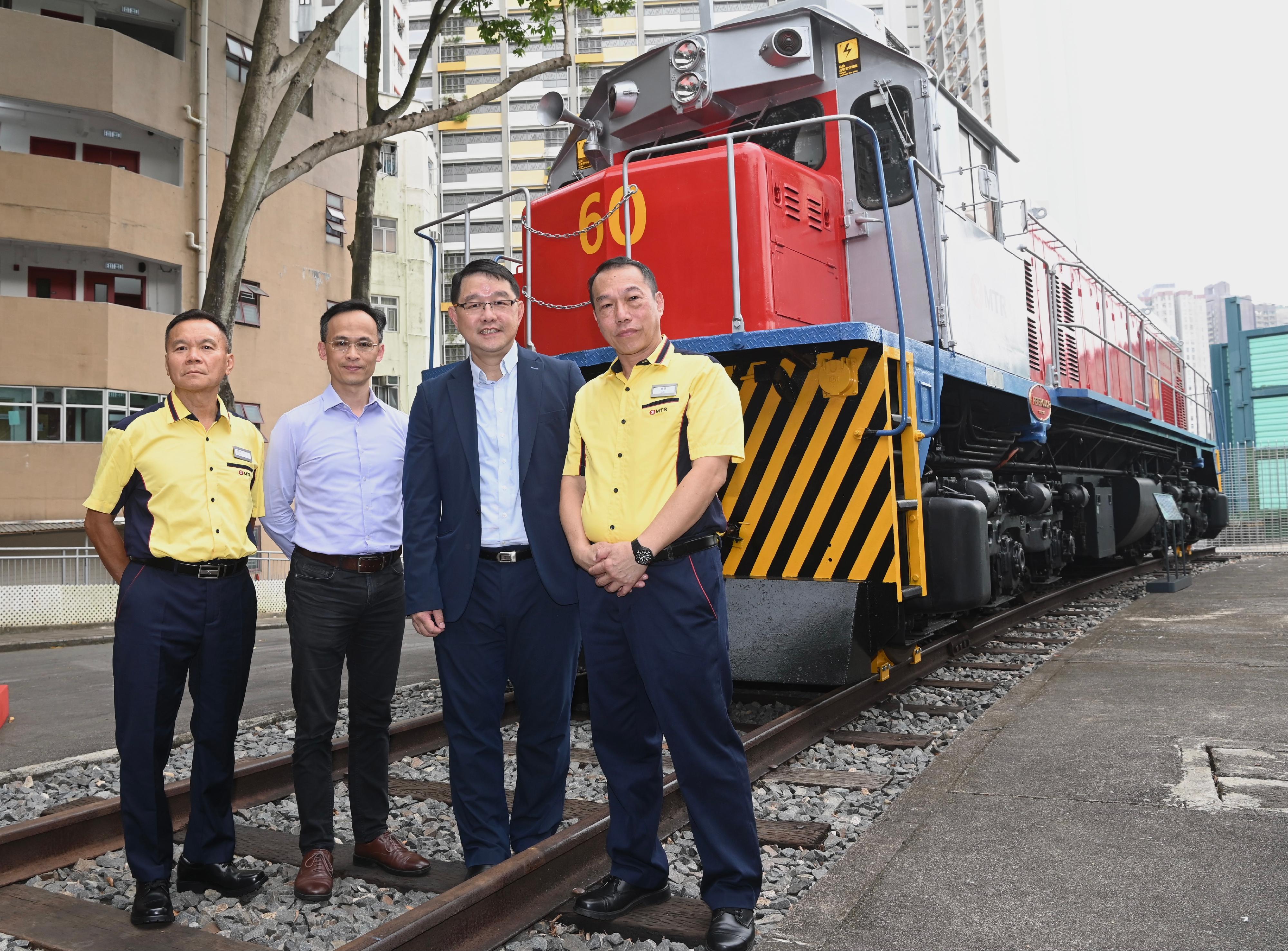 Diesel Electric Engine No. 60 - "Peter Quick" (L60) will be put on display at the Hong Kong Railway Museum starting from tomorrow (October 4). Photo shows the Museum Director of the Hong Kong Heritage Museum, Mr Brian Lam (second right), the Curator (3D Objects) of the Conservation Office, Mr Jonathan Tse (second left), and two former drivers of L60, Mr Ko Tak-tim (first left), and Mr Cheung Shun-chuen (first right), with L60.