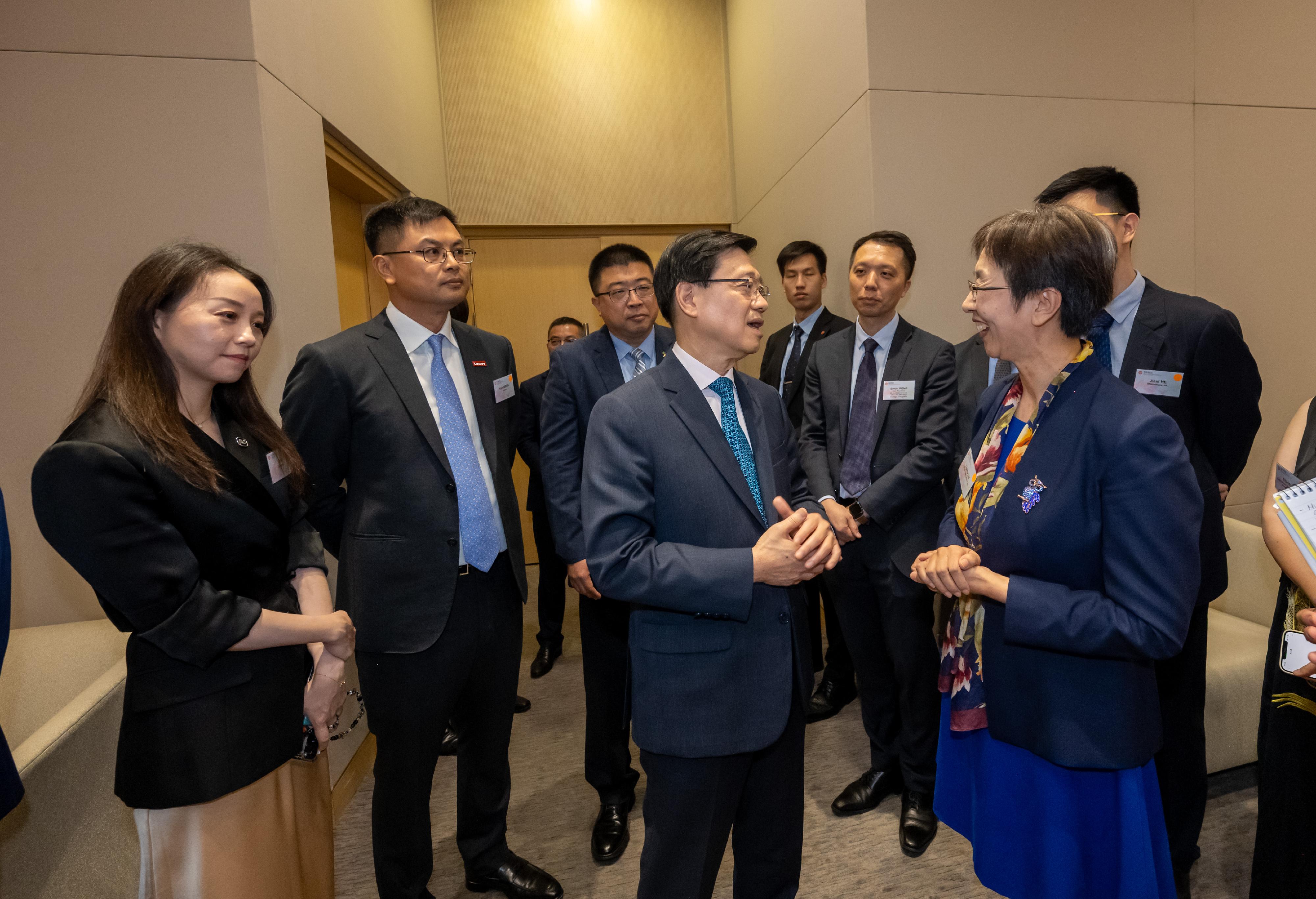 The Office for Attracting Attracting Strategic Enterprises (OASES) held the Launching Ceremony of OASES Partnership. Photo shows the Chief Executive, Mr John Lee (second right), interacting with the representatives of strategic enterprises.