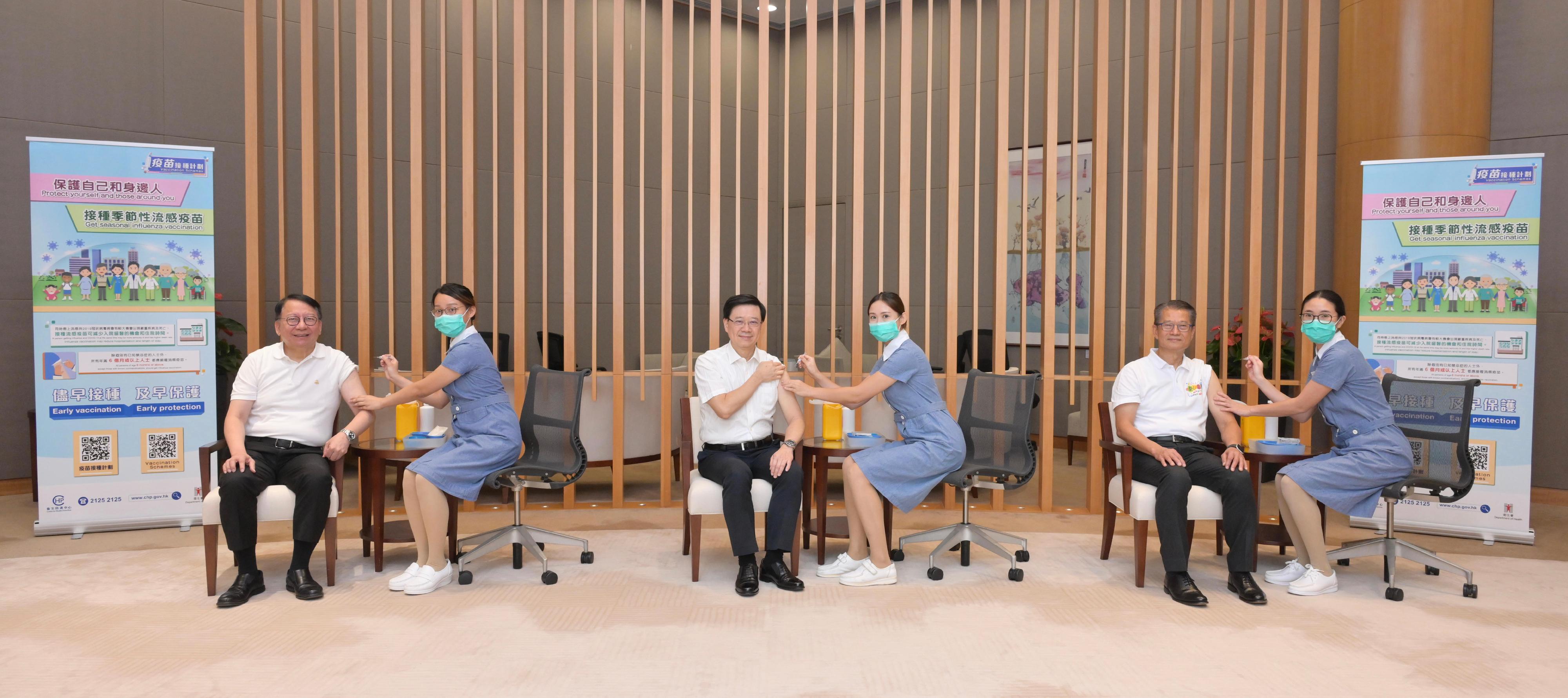 The Chief Executive, Mr John Lee (third left); the Chief Secretary for Administration, Mr Chan Kwok-ki (first left); and the Financial Secretary, Mr Paul Chan (second right), receive seasonal influenza vaccination today (October 5).