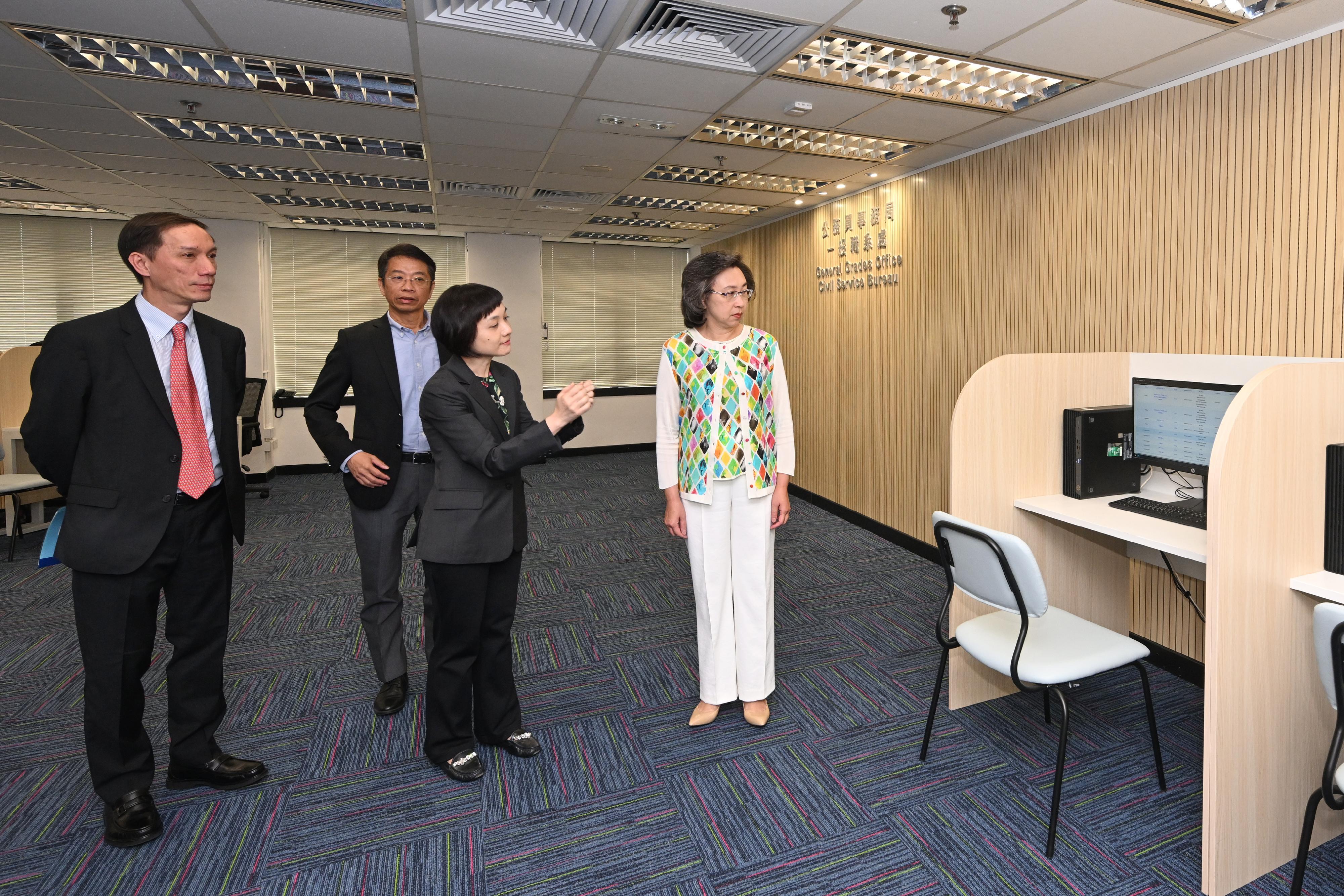 The Recruitment Centre, General Grades Office of the Civil Service Bureau officially commenced operation today (October 6) to conduct year-round recruitment for the posts of Assistant Clerical Officer, Clerical Assistant and Personal Secretary II. Photo shows the Secretary for the Civil Service, Mrs Ingrid Yeung (first right), and the Permanent Secretary for the Civil Service, Mr Clement Leung (second left), visiting the Recruitment Centre to learn how the candidates who wish to apply for the posts submit online applications via the computers at the Recruitment Centre. Looking on is  the Director of General Grades of the Civil Service Bureau, Mr Hermes Chan (first left).