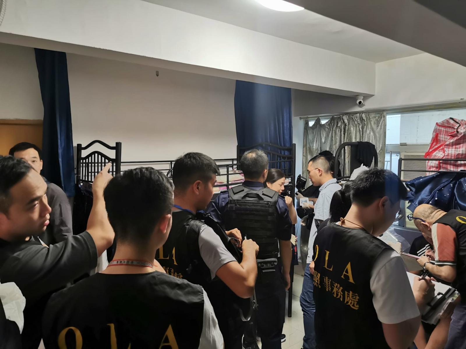 The Office of the Licensing Authority (OLA) of the Home Affairs Department today (October 10) conducted a joint operation with the Immigration Department to inspect premises in Sham Shui Po that was suspected of operating unlicensed bedspace apartment. Photo shows OLA enforcement officers searching for evidence in a suspected unlicensed bedspace apartment.