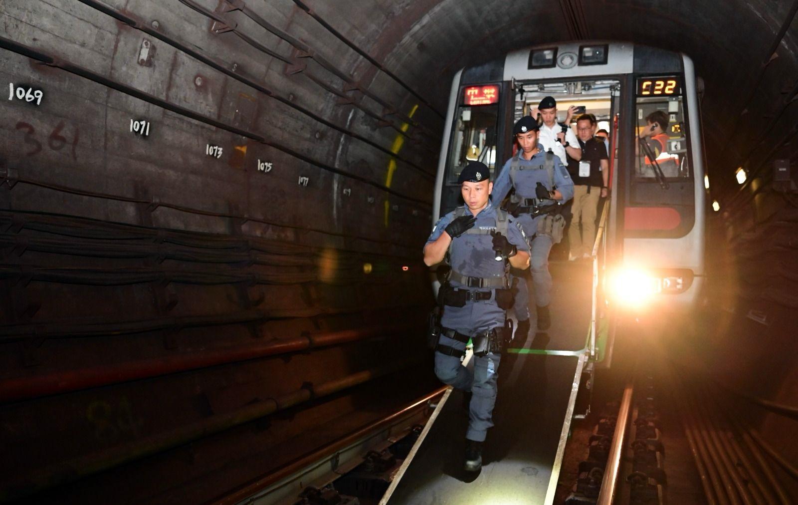 The Hong Kong Police Force, together with the MTR Corporation, the Fire Services Department, the Auxiliary Medical Service, St John Ambulance conducted an inter-departmental response exercise in the early hours today (October 14). Picture shows officers enter the tunnel for initial investigations and search for casualties.