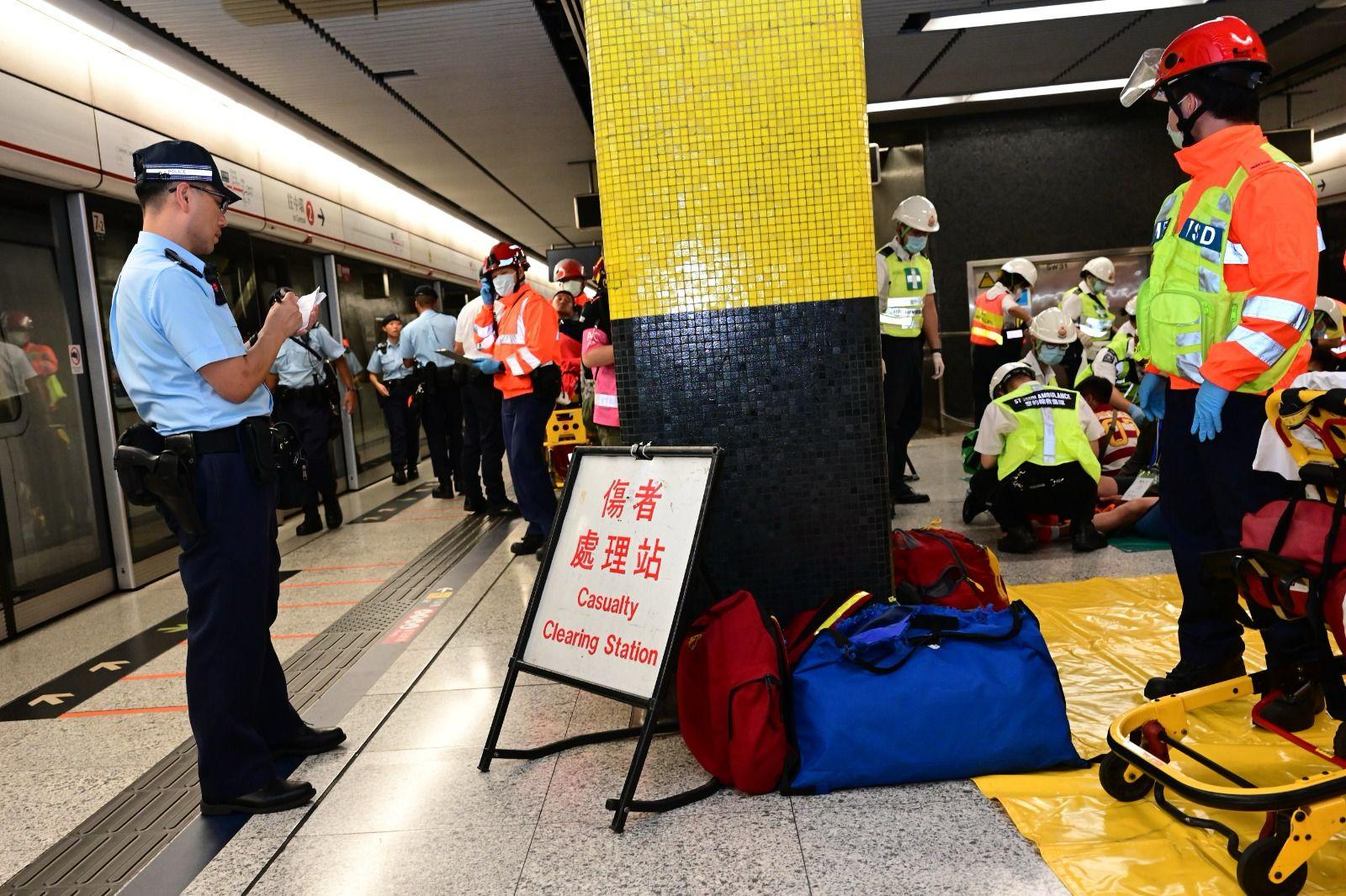 The Hong Kong Police Force (HKPF), together with the MTR Corporation (MTRC), the Fire Services Department (FSD), the Auxiliary Medical Service, St John Ambulance conducted an inter-departmental response exercise in the early hours today (October 14). Picture shows HKPF officers maintain close communication with MTRC staff and FSD officers at a platform to keep track on the latest situation of the incidents.