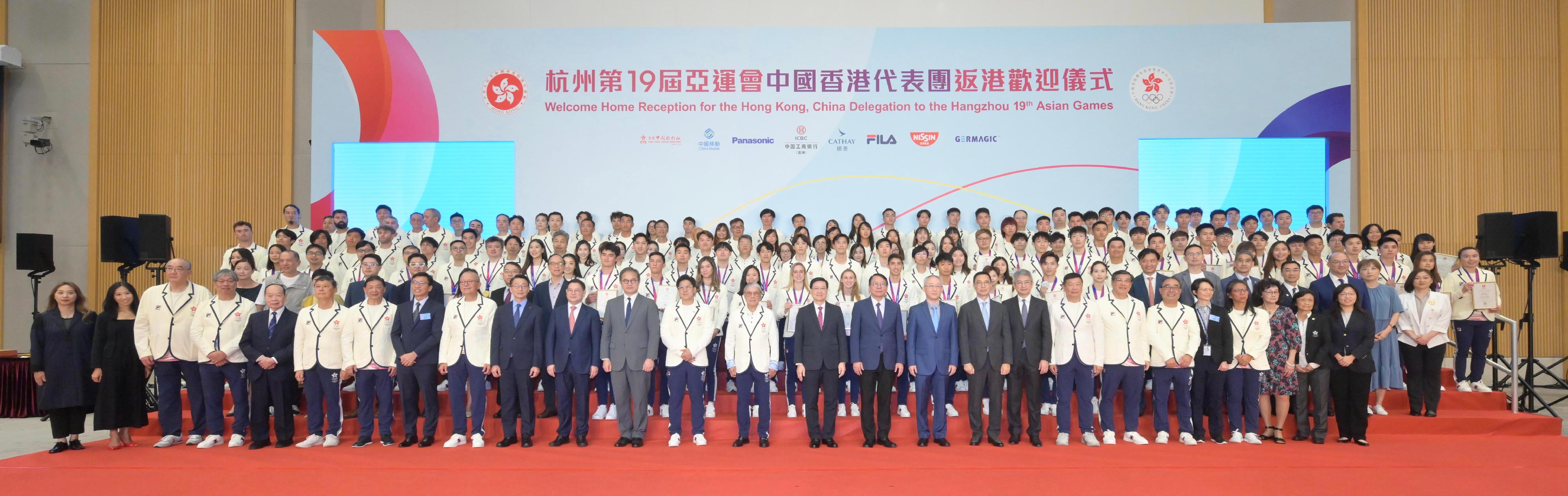 The Chief Executive, Mr John Lee, attended the welcome home reception for the Hong Kong, China Delegation to the 19th Asian Games Hangzhou today (October 14). Photo shows (front row, from eighth left) the Commissioner for Sports in the Culture, Sports and Tourism Bureau, Mr Sam Wong; the Chairman of the Major Sports Events Committee, Dr Karl Kwok; the Director of Leisure and Cultural Services, Mr Vincent Liu; Deputy Director-General of the Department of Publicity, Cultural and Sports Affairs of the Liaison Office of the Central People's Government in the Hong Kong Special Administrative Region (HKSAR) Mr Zhang Guoyi; the Permanent Secretary for Culture, Sports and Tourism, Mr Joe Wong; the Chef de Mission of the Hong Kong, China Delegation to the Asian Games, Mr Kenneth Fok; the President of the Sports Federation & Olympic Committee of Hong Kong, China (SF&OC), Mr Timothy Fok; Mr Lee; the Chief Secretary for Administration, Mr Chan Kwok-ki; the Acting Commissioner of the Office of the Commissioner of the Ministry of Foreign Affairs of the People's Republic of China in the HKSAR, Mr Li Yongsheng; the Secretary for Culture, Sports and Tourism, Mr Kevin Yeung; the Under Secretary for Culture, Sports and Tourism, Mr Raistlin Lau; the Honorary Secretary General of the SF&OC, Mr Edgar Yang, with other guests, athletes and members of the Delegation at the reception. 