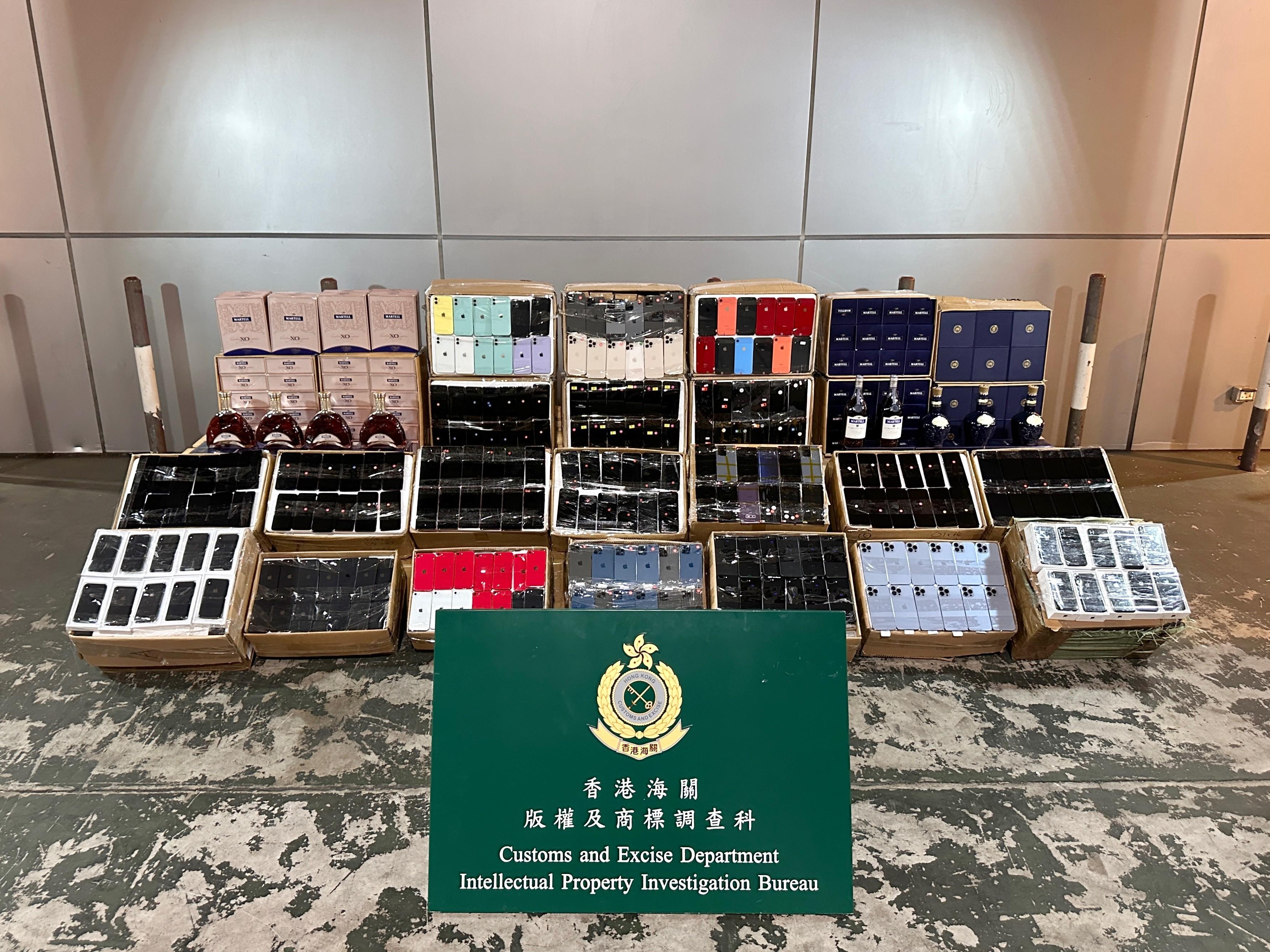 Hong Kong Customs on October 4 seized about 8 400 suspected counterfeit goods and about 260 litres of suspected duty-not-paid liquor at the Tuen Mun River Trade Terminal Customs Cargo Examination Compound. The total estimated market value was about $11 million, with a duty potential of about $ 260,000. Photo shows the suspected counterfeit goods and the suspected duty-not-paid liquor seized.