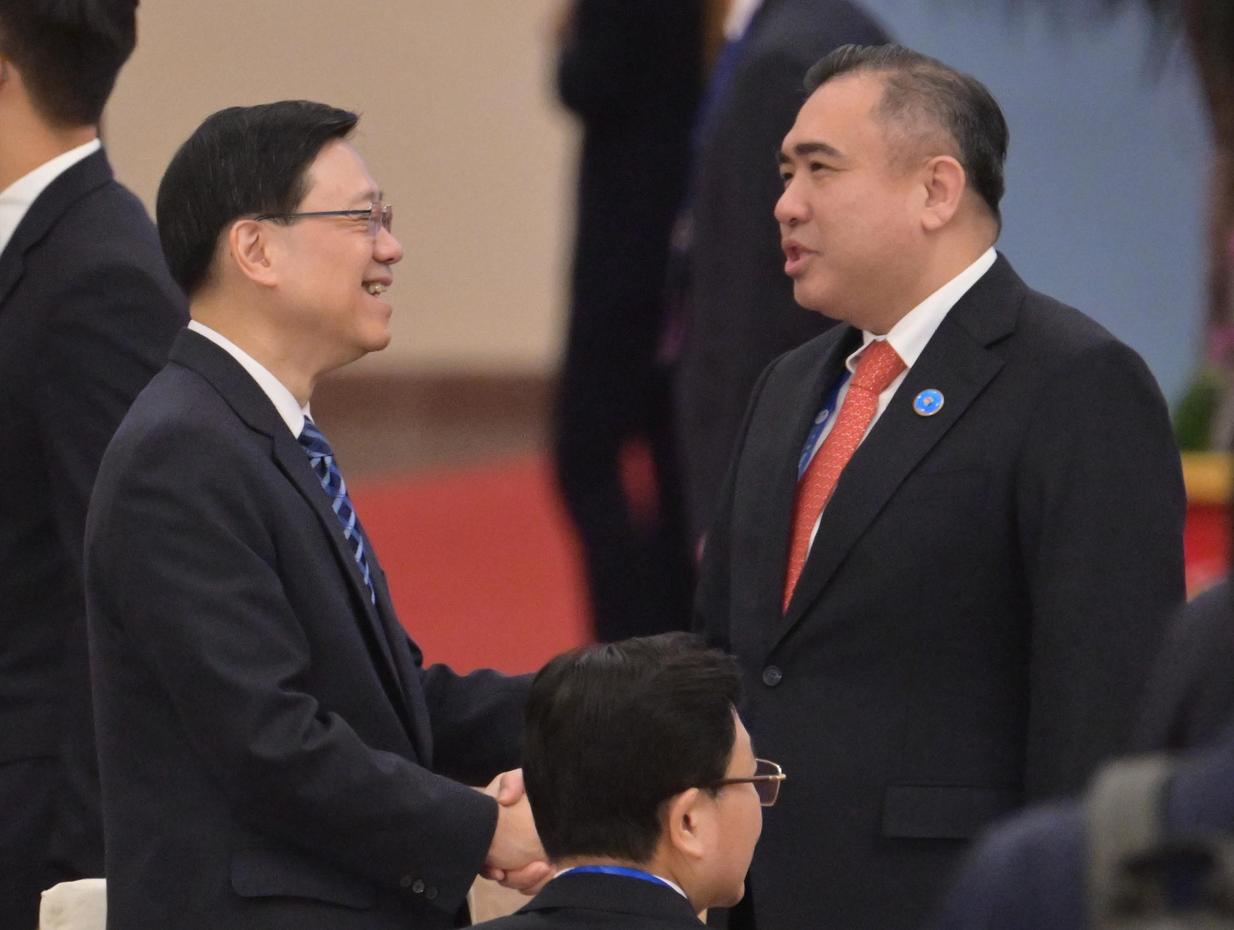 The Chief Executive, Mr John Lee, led a high-level Hong Kong Special Administrative Region delegation comprising senior government officials and members of various sectors to participate in the third Belt and Road Forum for International Cooperation in Beijing today (October 18). Photo shows Mr Lee (left) exchanging views with the Minister of Transport of Malaysia, Mr Loke Siew Fook (right), at the opening ceremony of the Forum this morning.