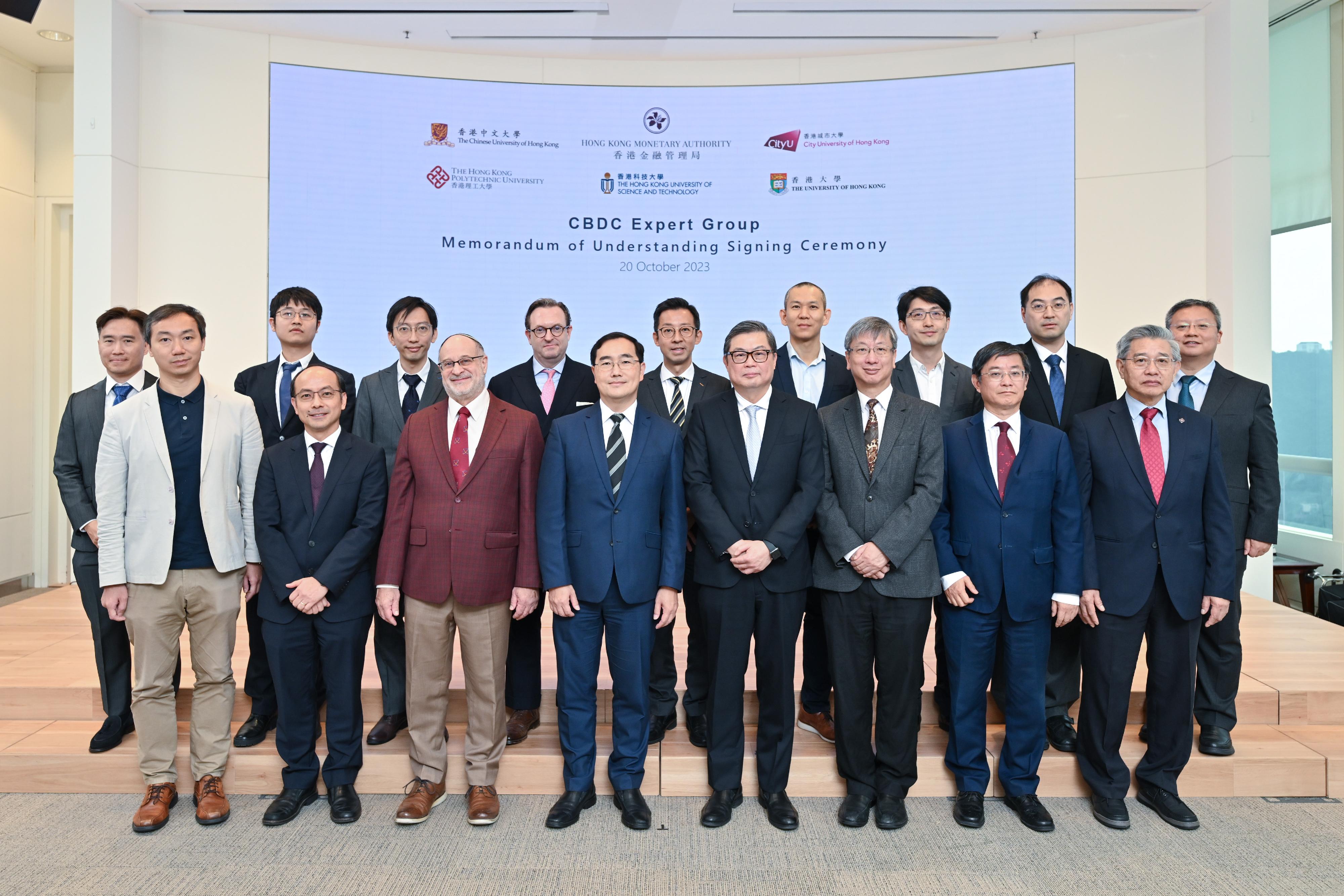 The Executive Director (Financial Infrastructure) of the Hong Kong Monetary Authority, Mr Colin Pou (front row, fourth left), signs Memorandums of Understanding with five local universities whose faculty members are participants of the Central Bank Digital Currency Expert Group.
