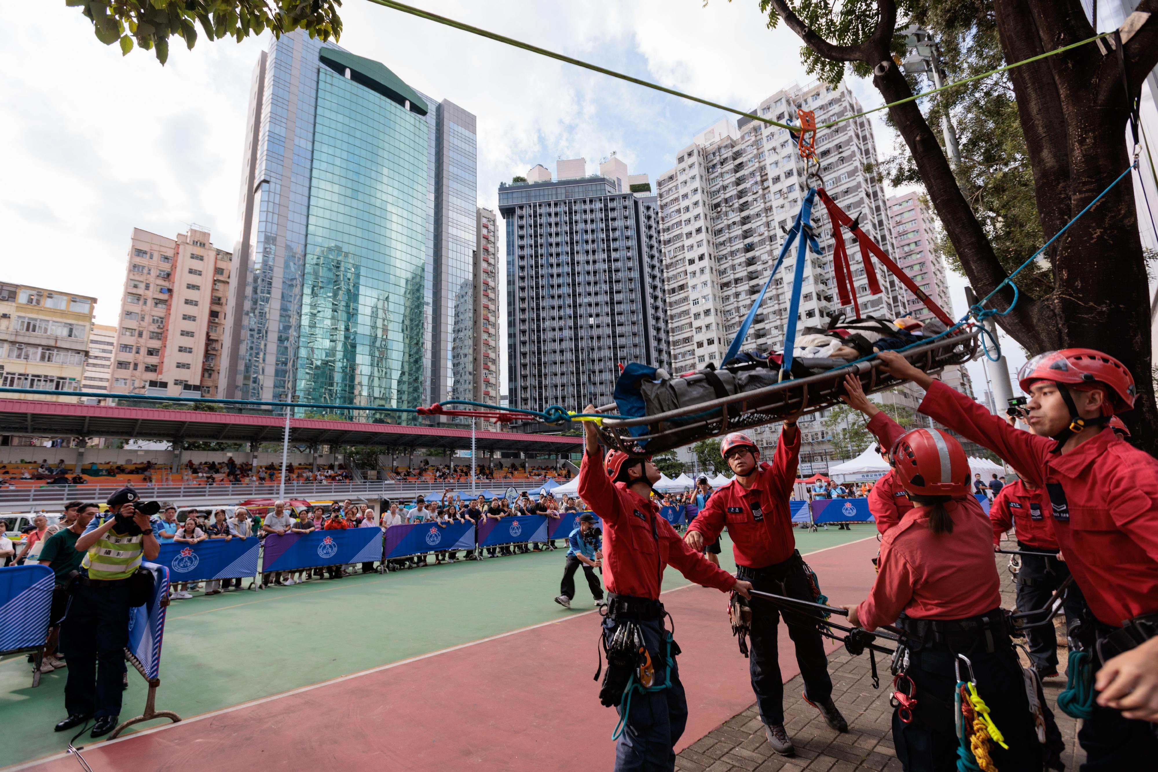 The Civil Aid Service (CAS) held the Mountain Safety Promotion Day with various government departments and mountaineering organisations today (October 22) at MacPherson Playground. Photo shows the CAS members demonstrating mountain rescue techniques.