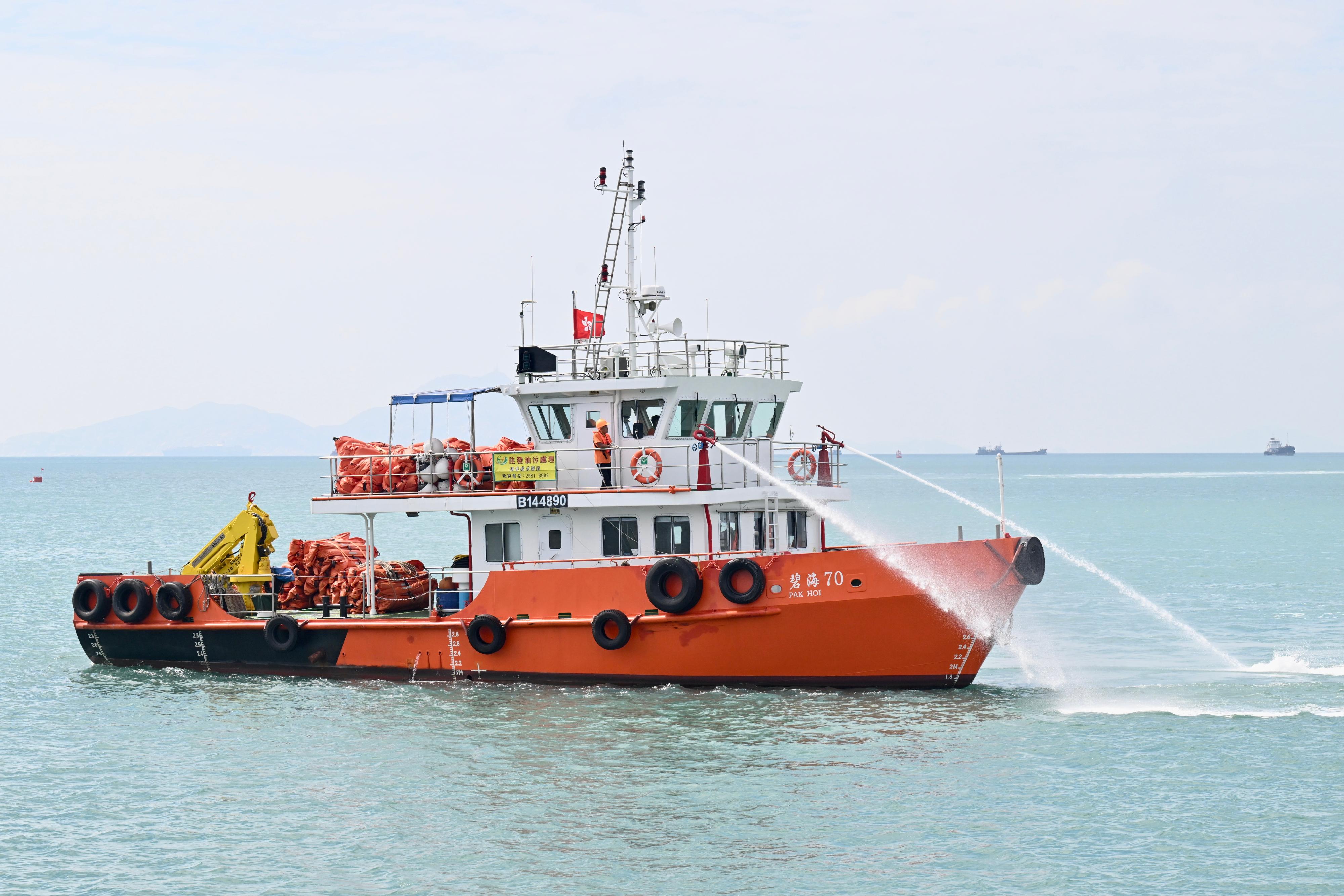 The annual marine pollution joint response exercises, code-named Oilex 2023 and Maritime Hazardous and Noxious Substances (HNS) 2023, were conducted by various government departments this morning (October 26) in the waters west of Lamma Island to test their marine pollution responses in the event of spillage of oil and HNS in Hong Kong waters. Photo shows a pollution control vessel simulating the spraying of oil dispersant with water.