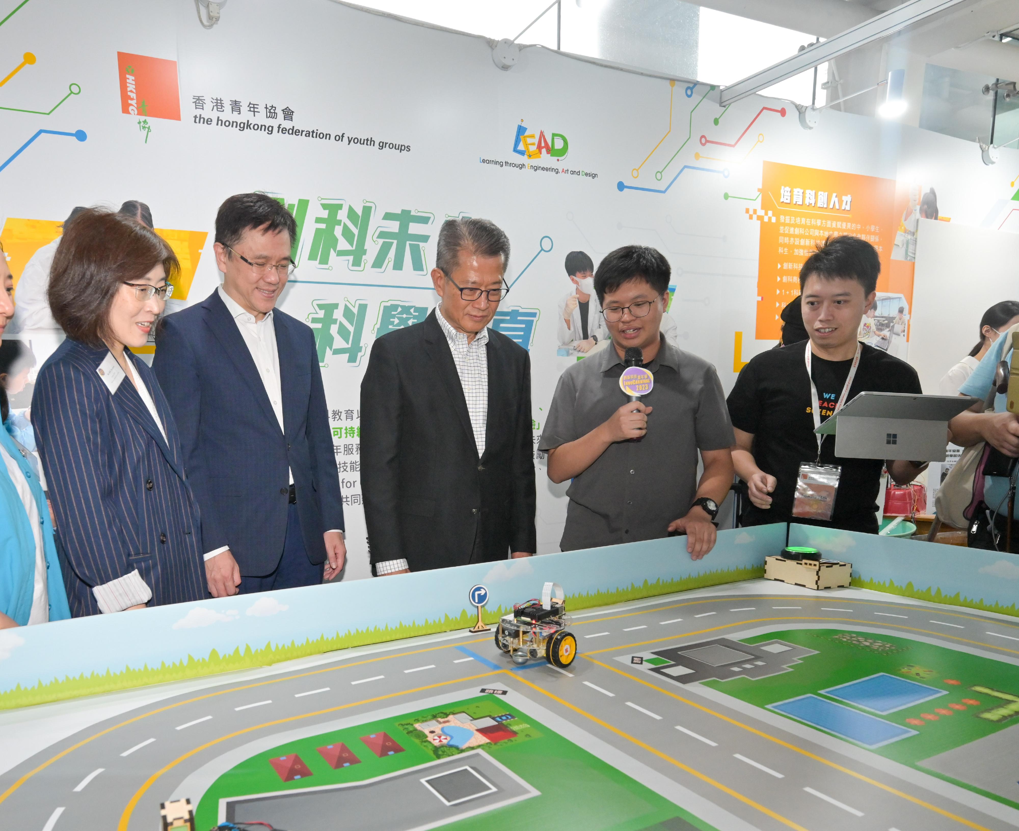The Financial Secretary, Mr Paul Chan, attended the opening ceremony of InnoCarnival 2023 today (October 28). Photo shows Mr Chan (centre), accompanied by the Secretary for Innovation, Technology and Industry, Professor Sun Dong (second left), and the Executive Director of the Hong Kong Federation of Youth Groups, Ms Helen Hsu (first left), visiting an exhibition booth of the Hong Kong Federation of Youth Groups.
