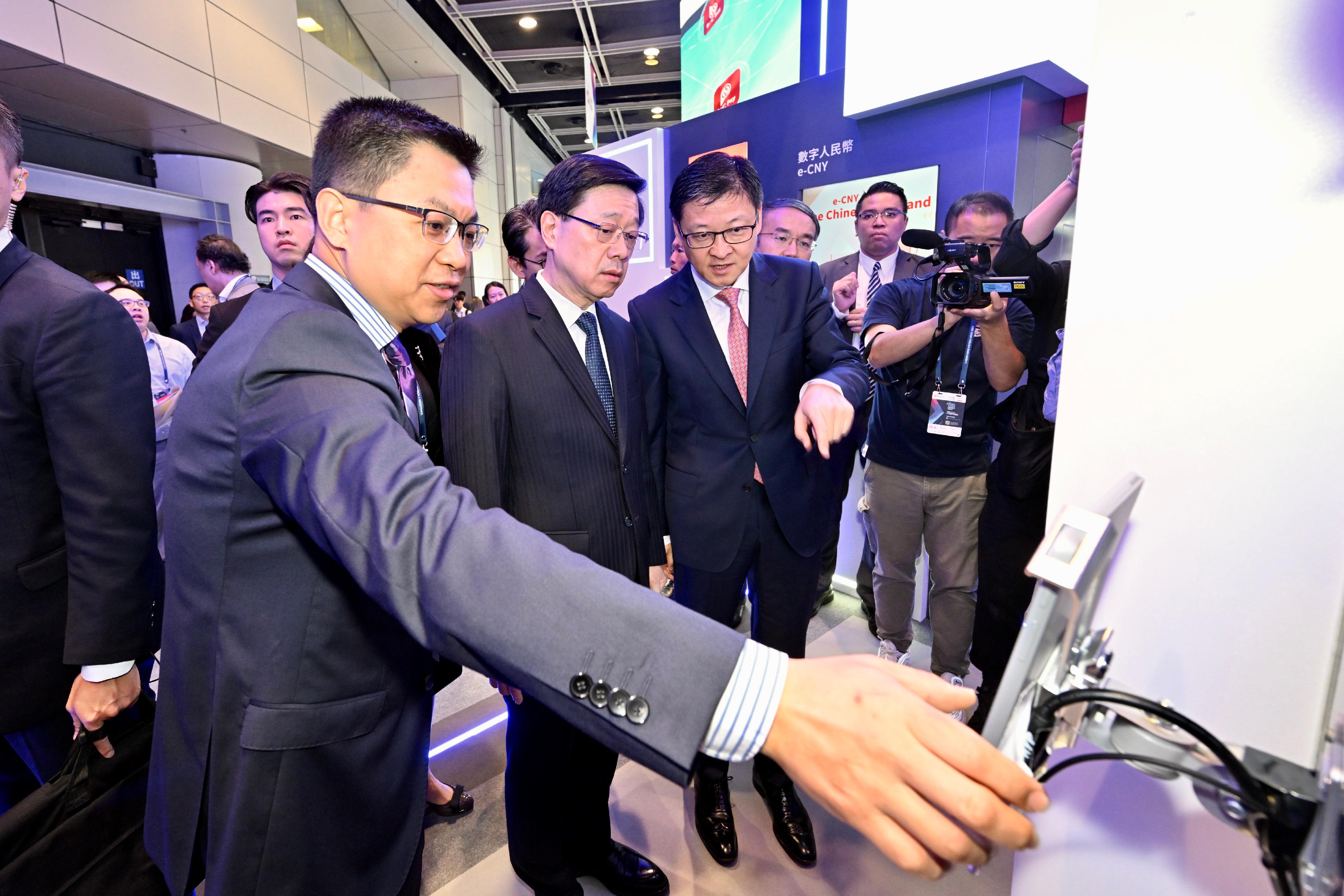 The Chief Executive, Mr John Lee, attended Hong Kong FinTech Week 2023 today (November 2). Photo shows Mr Lee (second left) touring an exhibition booth.
