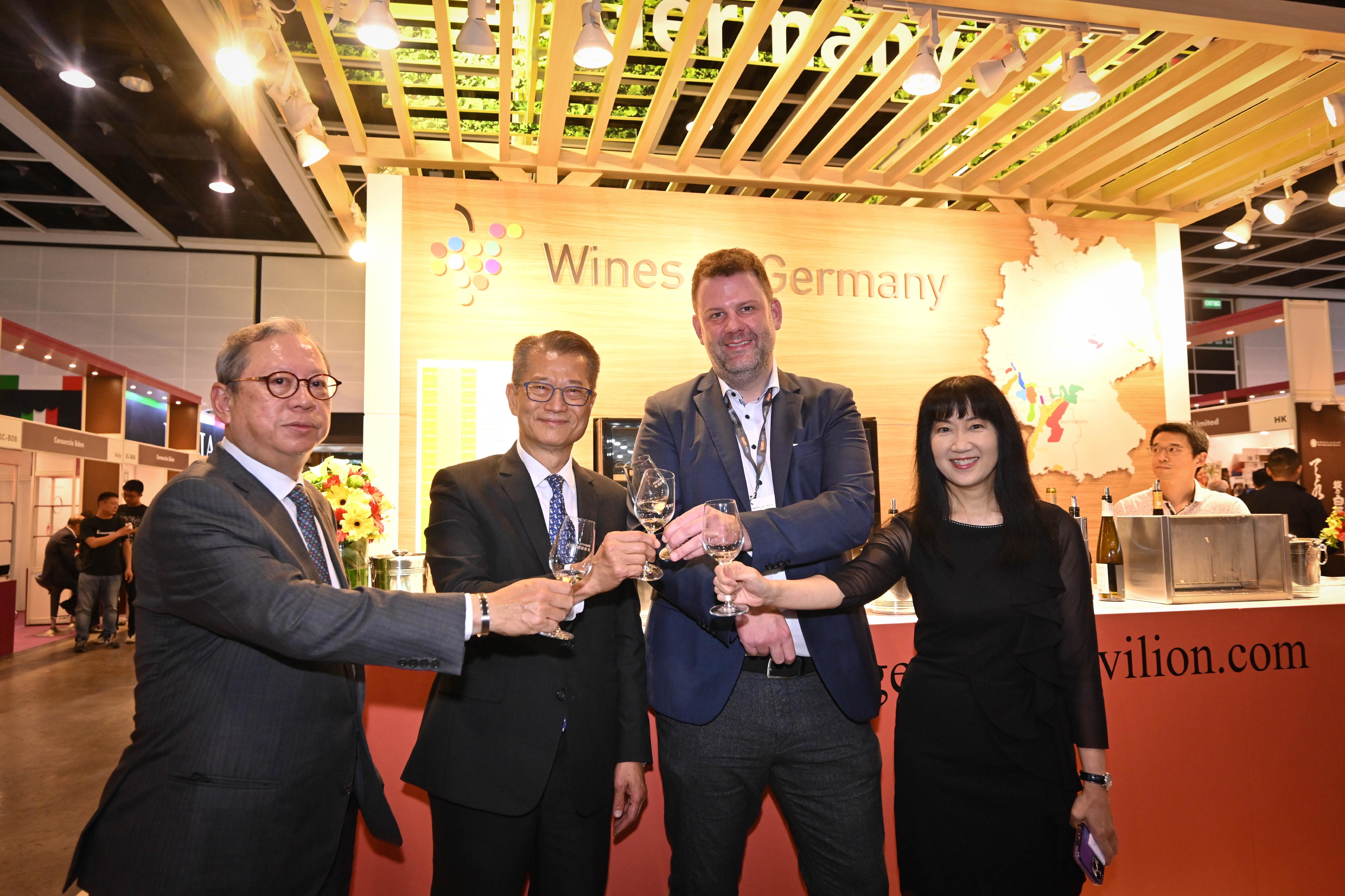 The Financial Secretary, Mr Paul Chan, attended the Hong Kong International Wine & Spirits Fair 2023 today (November 3). Photo shows Mr Chan (second left), accompanied by the Chairman of the Hong Kong Trade Development Council, Dr Peter Lam (first left), and the Executive Director of the Hong Kong Trade Development Council, Ms Margaret Fong (first right), touring an exhibition booth.