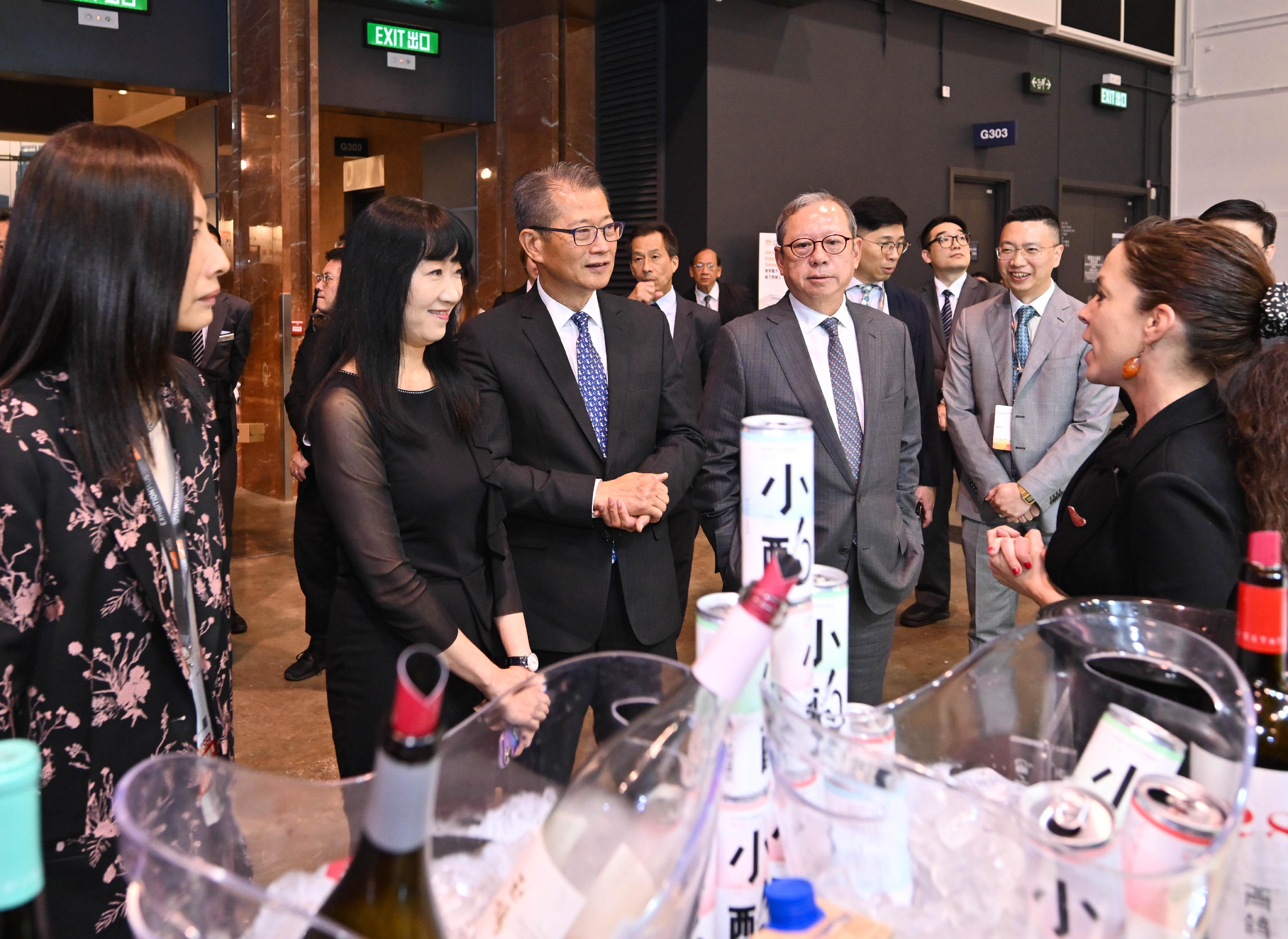 The Financial Secretary, Mr Paul Chan, attended the Hong Kong International Wine & Spirits Fair 2023 today (November 3). Photo shows Mr Chan (third left), accompanied by the Chairman of the Hong Kong Trade Development Council, Dr Peter Lam (fourth left), and the Executive Director of the Hong Kong Trade Development Council, Ms Margaret Fong (second left), touring an exhibition booth.
