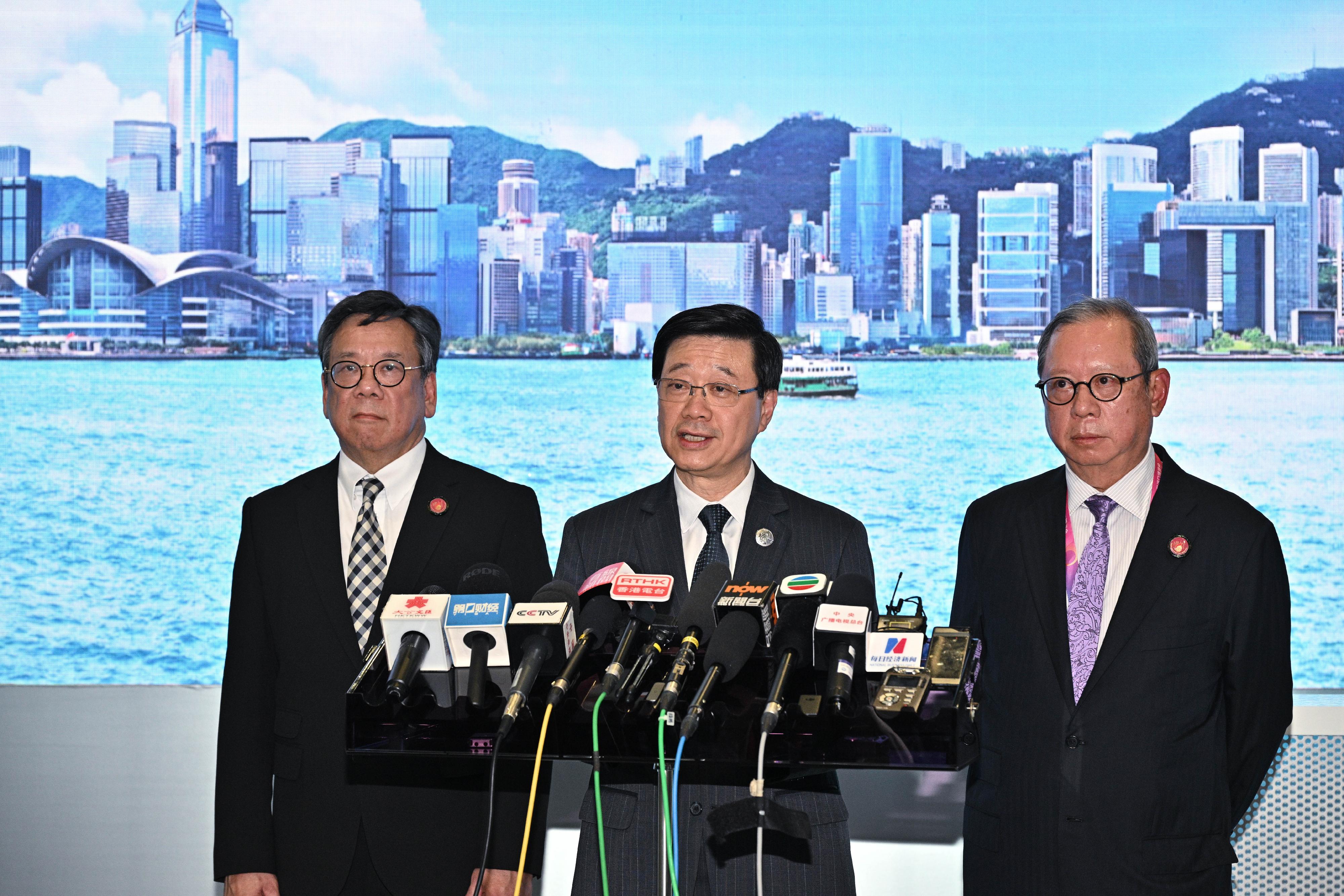 The Chief Executive, Mr John Lee (centre), with the Secretary for Commerce and Economic Development, Mr Algernon Yau (left), and the Chairman of the Hong Kong Trade Development Council, Dr Peter Lam (right), meet the media in Shanghai to conclude the visit today (November 5).