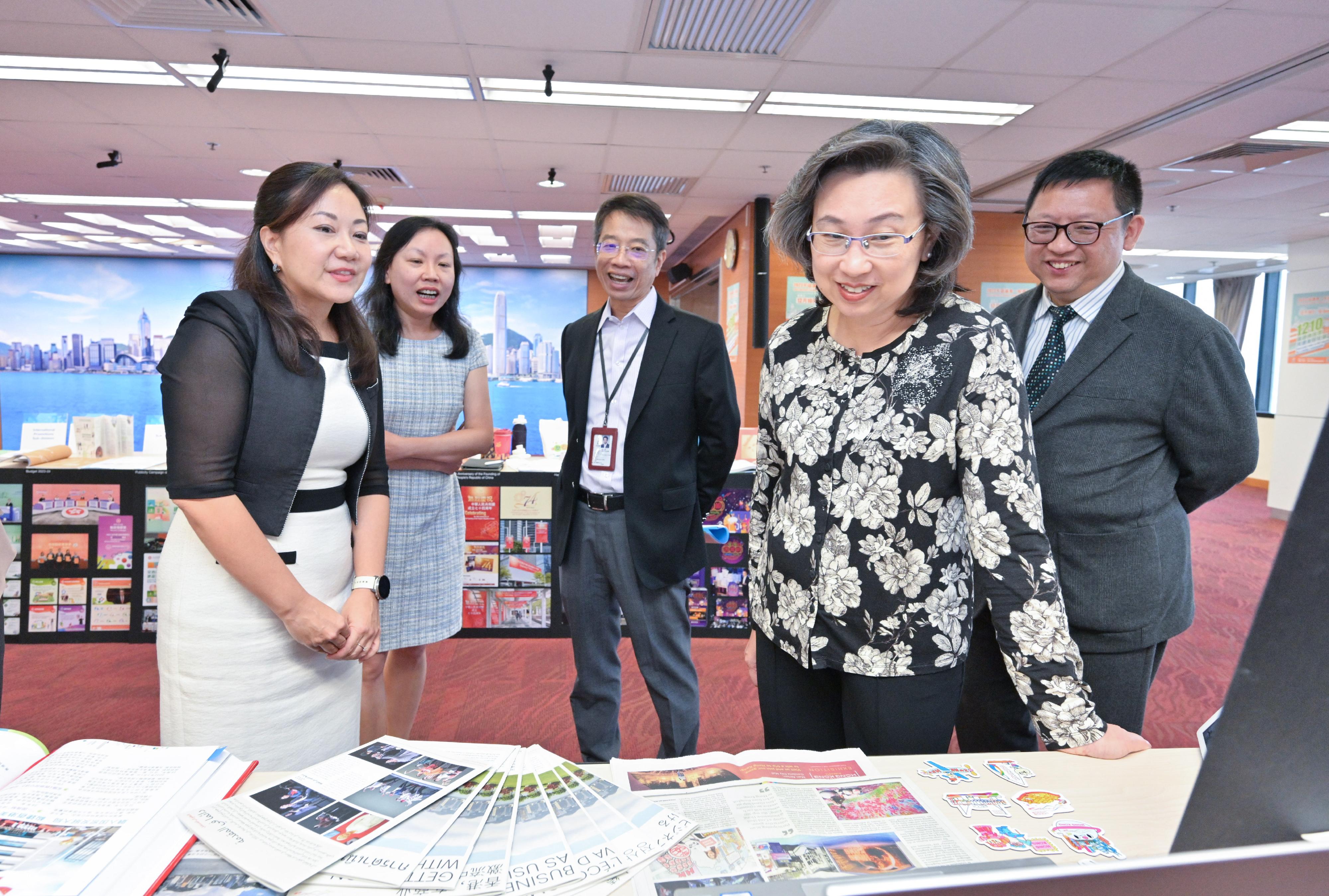 The Secretary for the Civil Service, Mrs Ingrid Yeung, visited the Information Services Department today (November 6). Photo shows Mrs Yeung (second right) being briefed on the department's latest effort in public relations and promotions locally and outside Hong Kong while conversing with staff from the Overseas Public Relations Sub-division. Looking on are the Permanent Secretary for the Civil Service, Mr Clement Leung (centre); the Director of Information Services, Mr Fletch Chan (first right); and Deputy Director of Information Services Ms Grace Ng (second left).