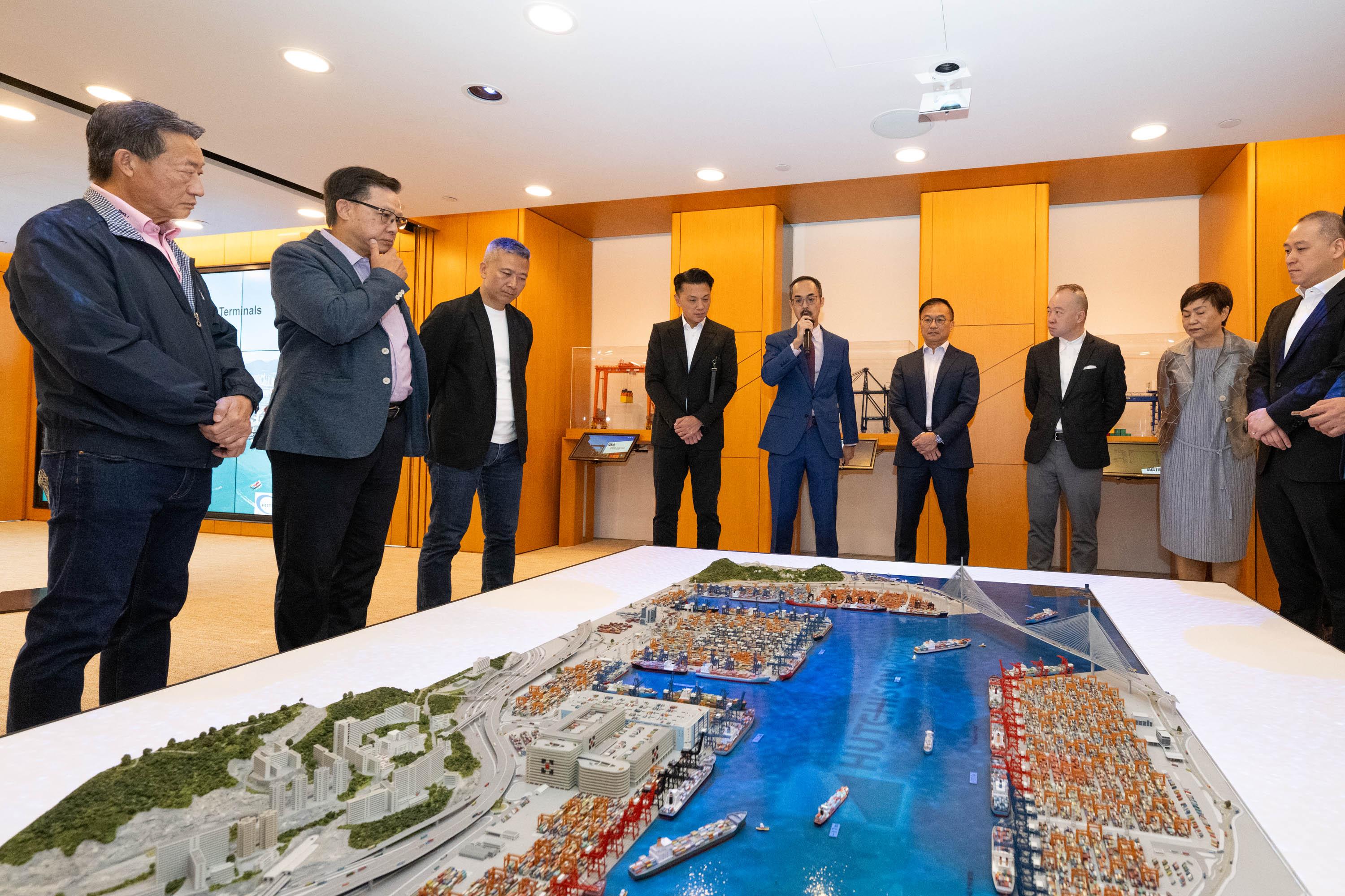The Legislative Council (LegCo) Panel on Economic Development visited the Kwai Tsing Container Terminals (KTCT) today (November 7) to further understand the latest developments of the terminals' digital operations and the logistics industry. Photo shows the Chairman of the Panel on Economic Development, Mr Sunny Tan (fourth left), and other Members receiving a briefing on port operations.