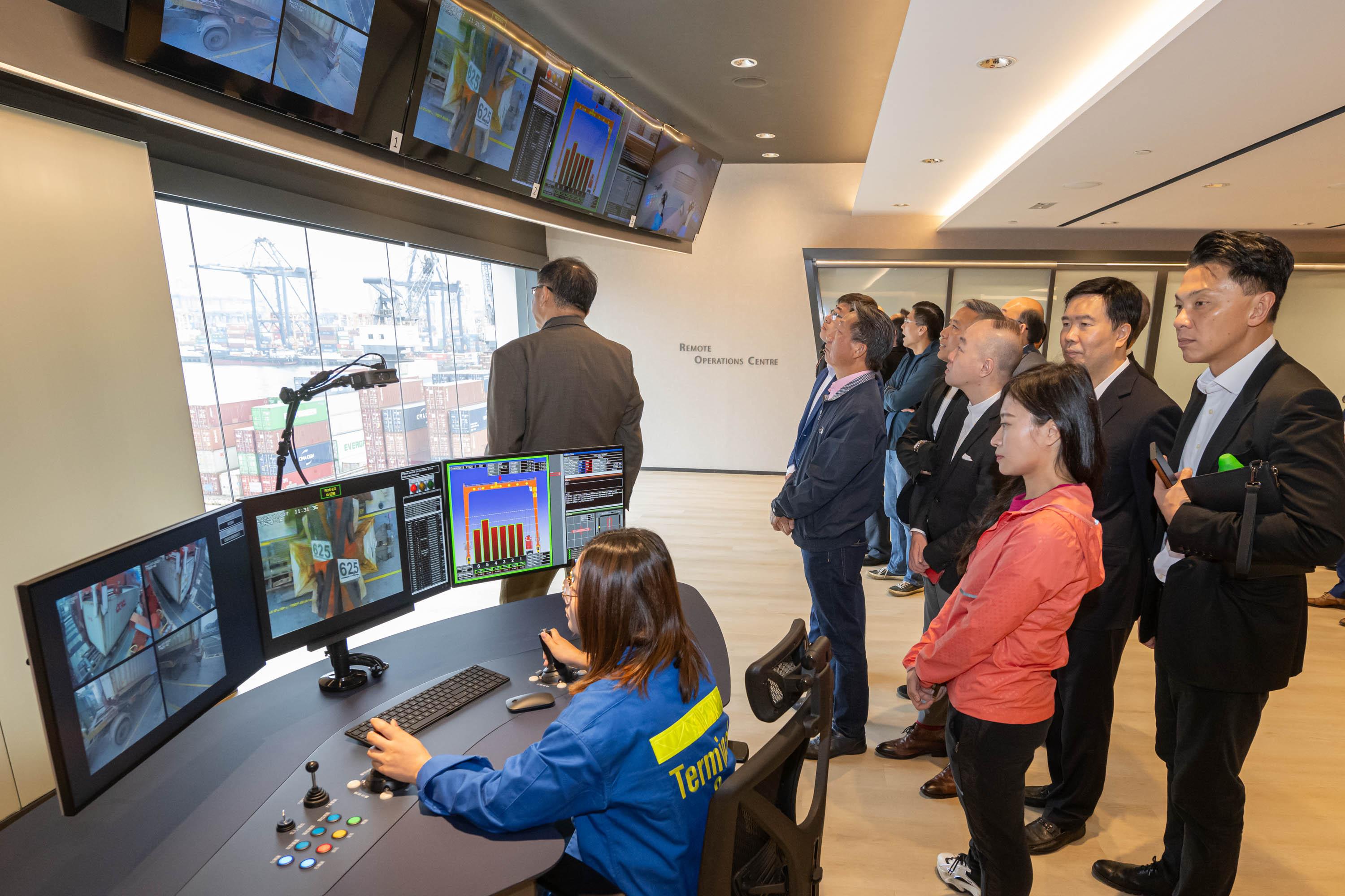 The Legislative Council (LegCo) Panel on Economic Development visited the Kwai Tsing Container Terminals (KTCT) today (November 7) to further understand the latest developments of the terminals' digital operations and the logistics industry. Photo shows the LegCo Members observing the remote-control cranes operation at the operation centre.