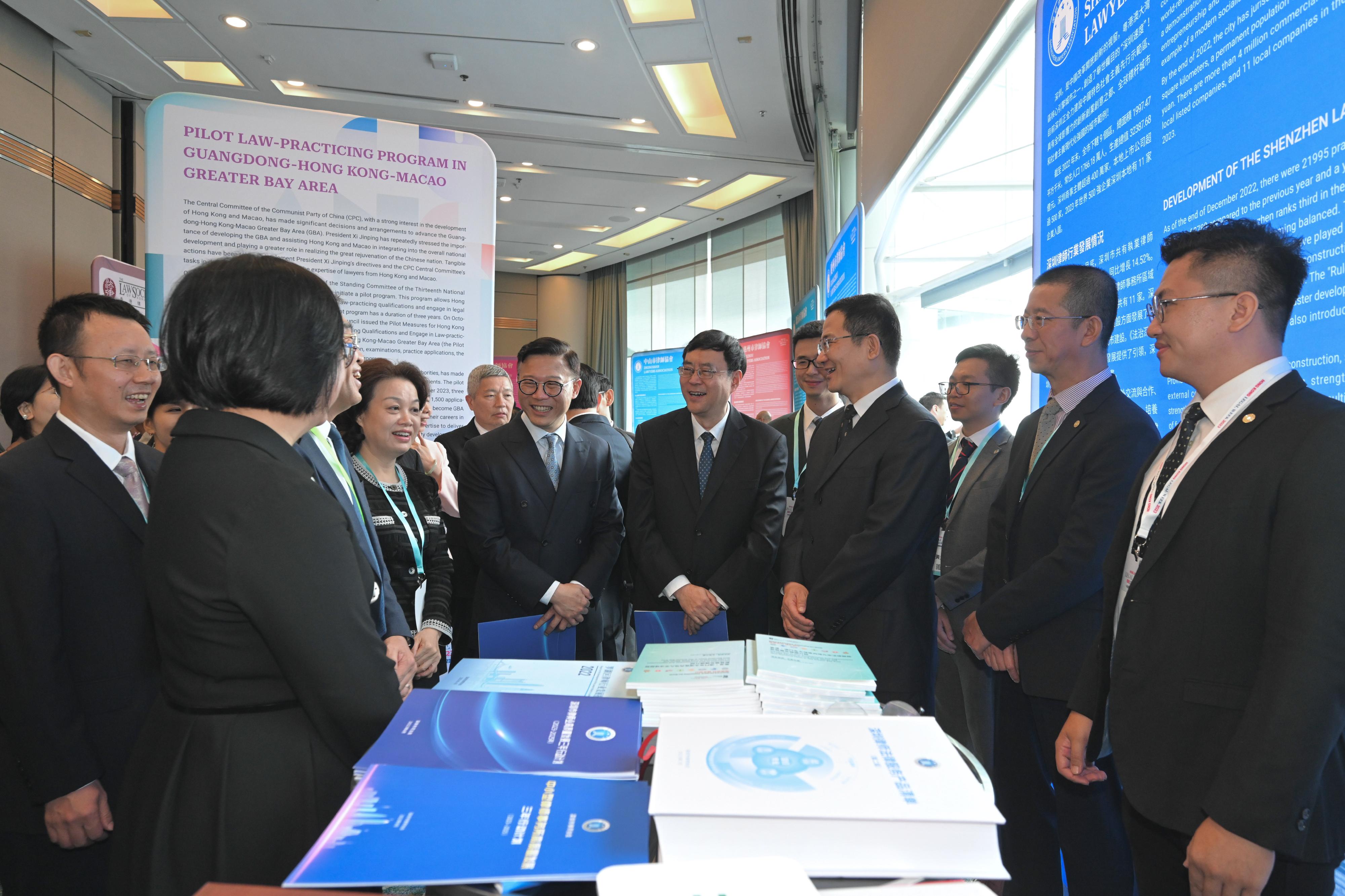 The Deputy Secretary for Justice, Mr Cheung Kwok-kwan (seventh right); the Director-General of the Department of Justice of Guangdong Province, Mr Chen Xudong (sixth right); and the Director of the Bureau of Lawyers' Work of the Ministry of Justice, Mr Tian Xin (fourth right), visit exhibition booths dedicated to promoting legal services set up at the Hong Kong Legal Week 2023 today (November 9), and chat with representatives from Hong Kong, Macao and the nine Mainland cities in the Guangdong-Hong Kong-Macao Greater Bay Area .
