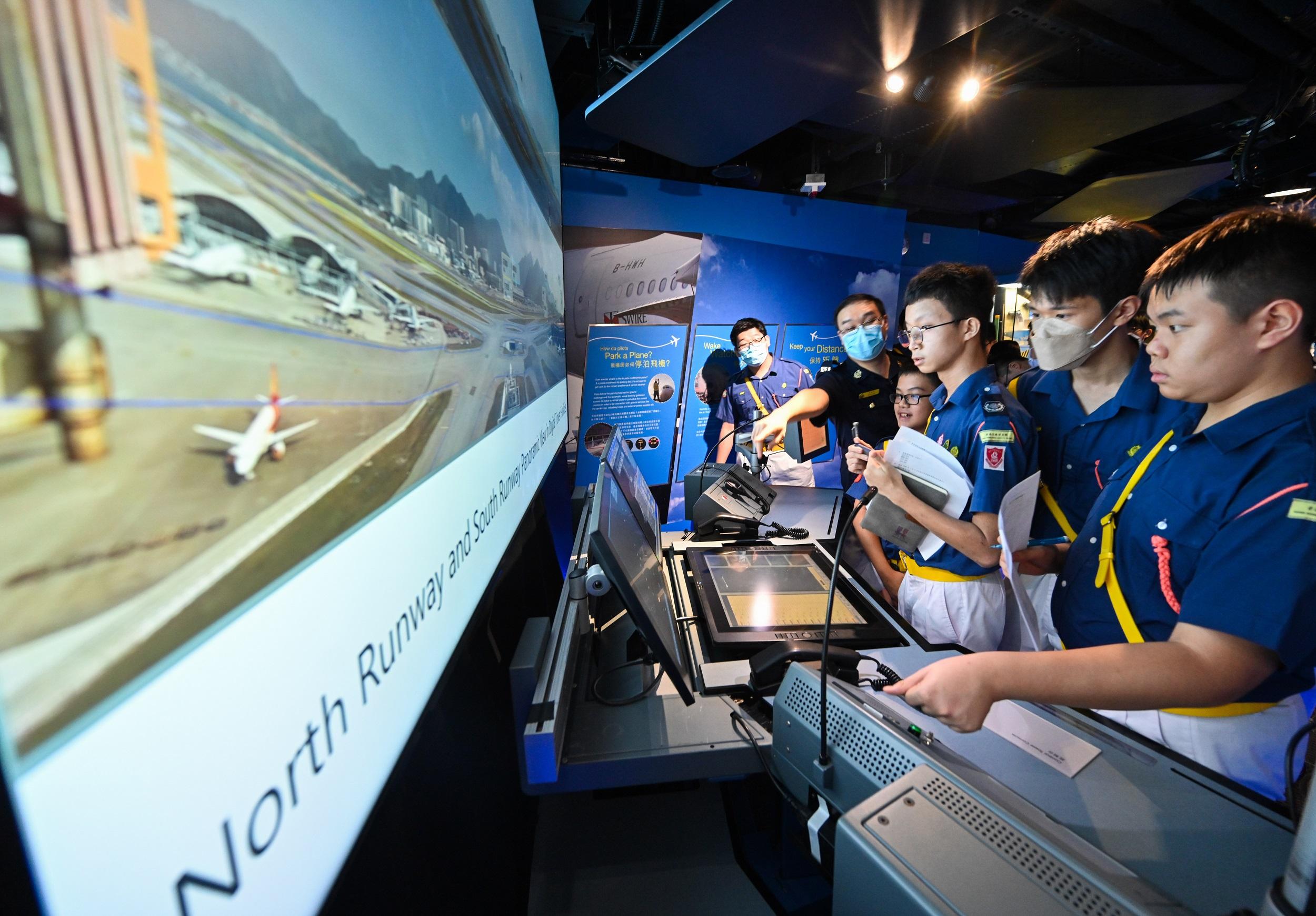 The Launching Ceremony of the "Aviation Safety Knowledge Badge Scheme" under the "Youth in Aviation"Programme jointly organised by the CAD and the Hong Kong Road Safety Patrol took place at the CAD Headquarters today (November 11). Photo shows participants of the scheme visiting the CAD Aviation Education Path guided by a docent.
