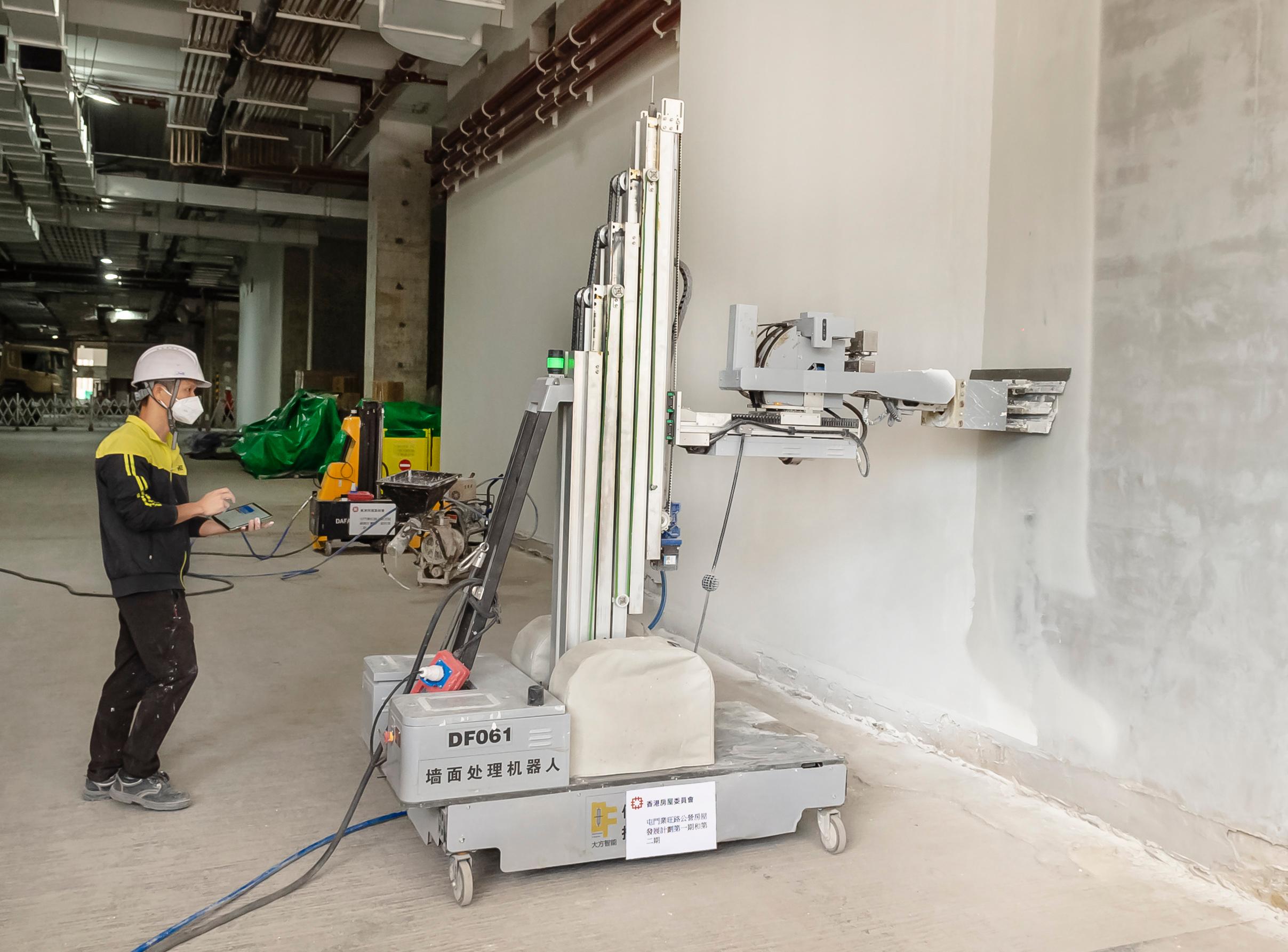 The Hong Kong Housing Authority introduced multifunctional indoor construction robot, the first of its kind, to boost safety at public housing sites. Photo shows a multifunctional indoor construction robot (larger size) performing skim coating works.