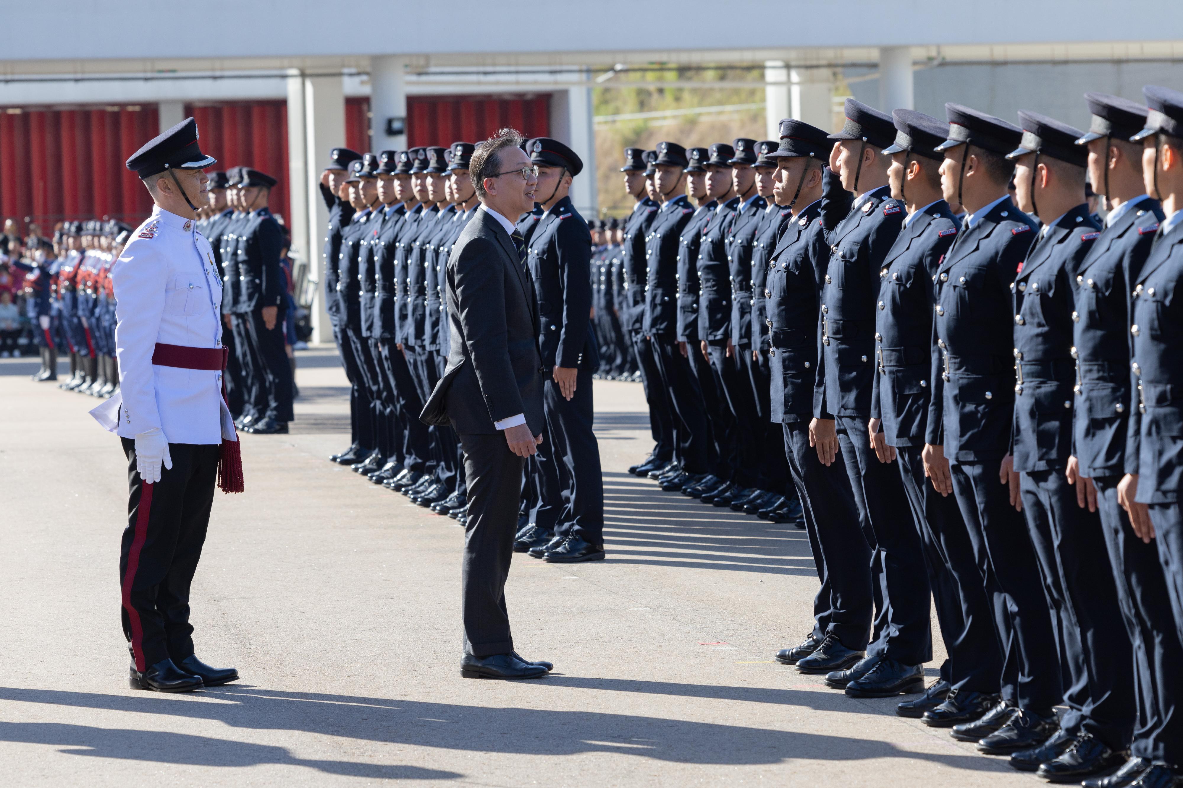 The Secretary for Justice, Mr Paul Lam, SC, reviews the Fire Services passing-out parade at the Fire and Ambulance Services Academy today (November 17).
