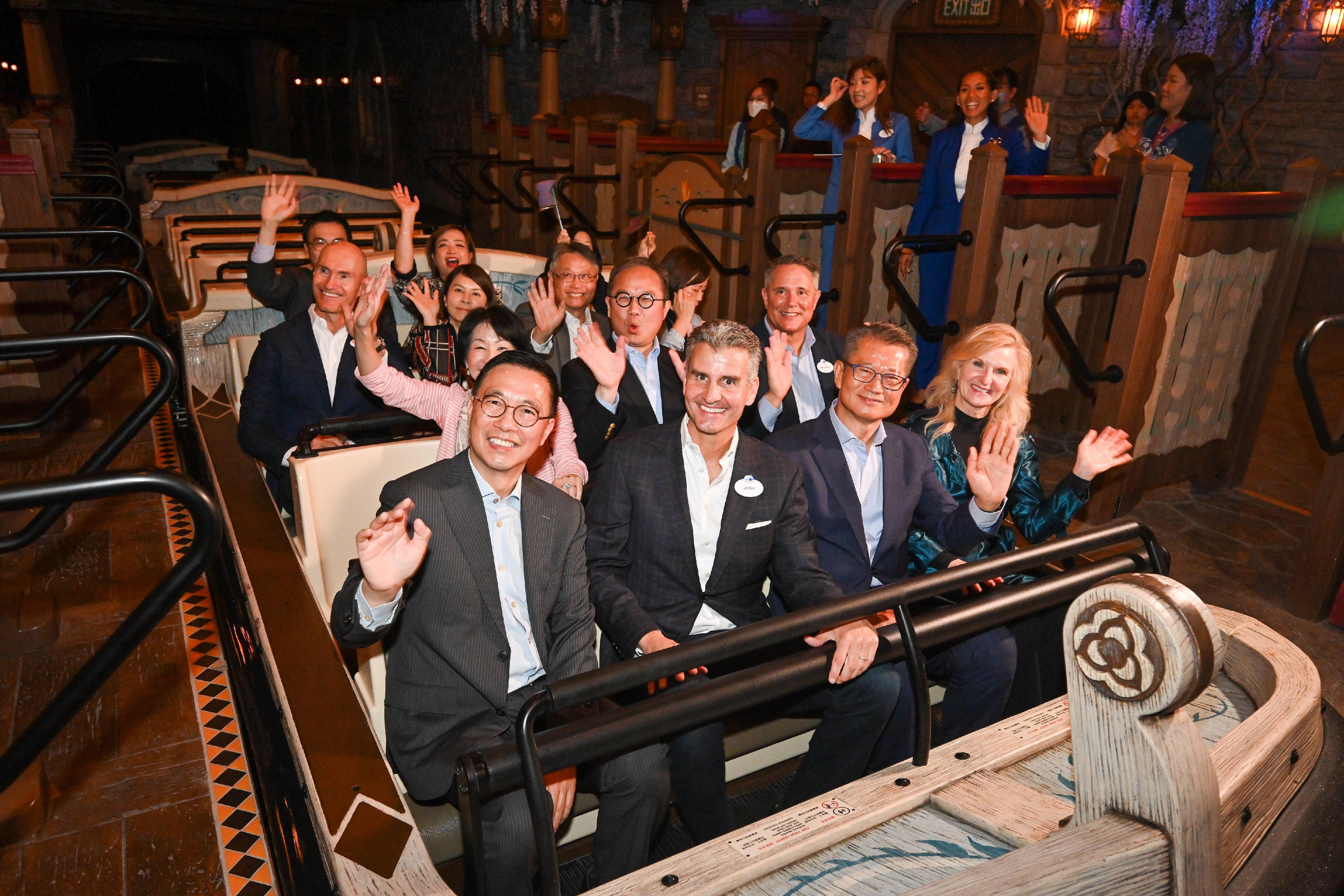 The Financial Secretary, Mr Paul Chan, attended the Hong Kong Disneyland Resort "A Welcome Ceremony for World of Frozen" today (November 20). Photo shows (first row, from left) the Secretary for Culture, Sports and Tourism, Mr Kevin Yeung; the Chairman of Disney Parks, Experiences and Products of the Walt Disney Company, Mr Josh D'Amaro; Mr Chan, and the President and Managing Director of Disney Parks International of the Walt Disney Company, Ms Jill Estorino, enjoying a ride at the Hong Kong Disneyland Resort.

