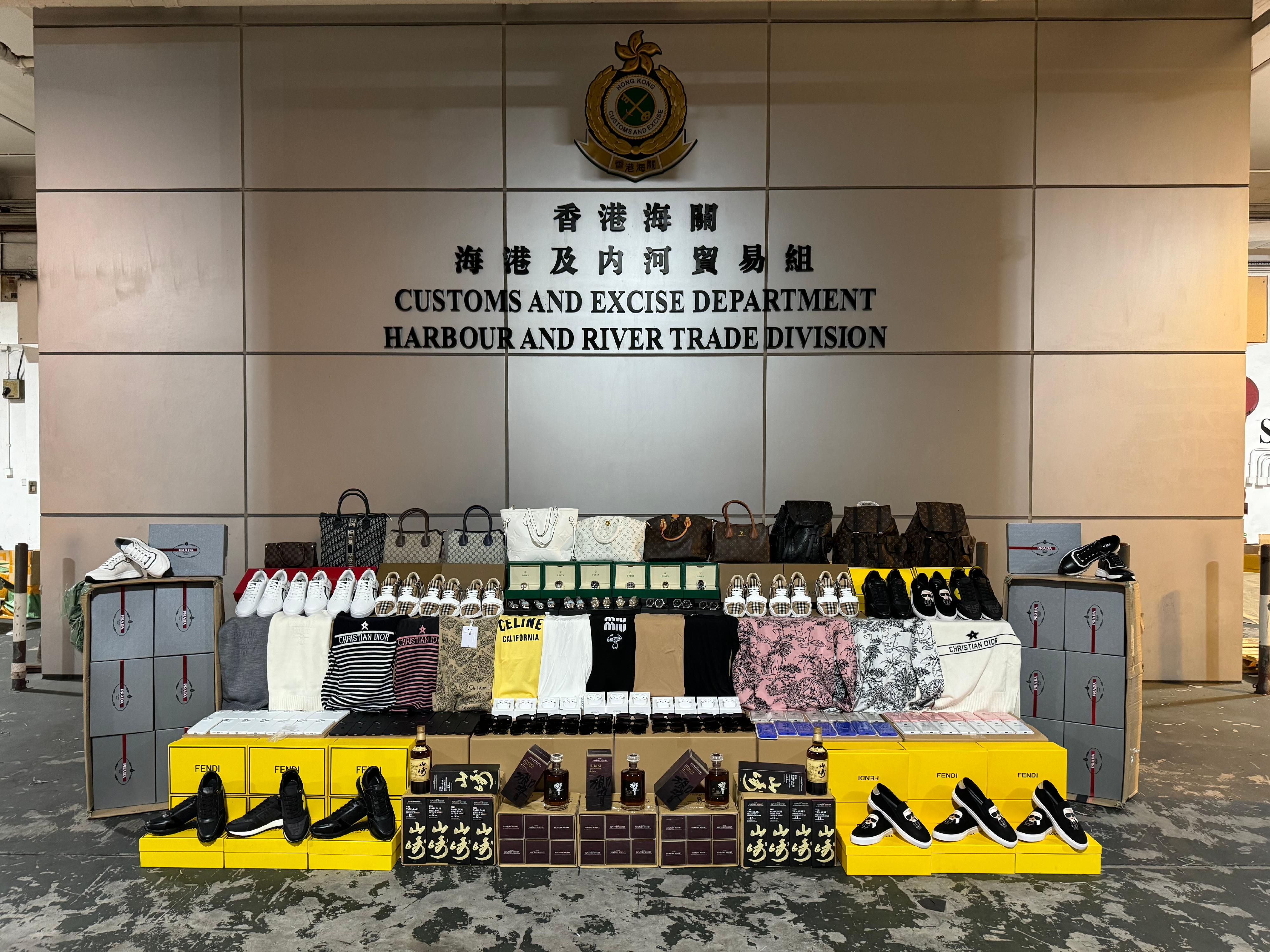 Hong Kong Customs on November 14 seized about 29 000 suspected counterfeit goods and about 34 litres of suspected duty-not-paid liquor at the Tuen Mun River Trade Terminal Customs Cargo Examination Compound. The total estimated market value was about $5.8 million, with a duty potential of about $90,000. Photo shows some of the suspected counterfeit goods and the suspected duty-not-paid liquor seized. 

 
