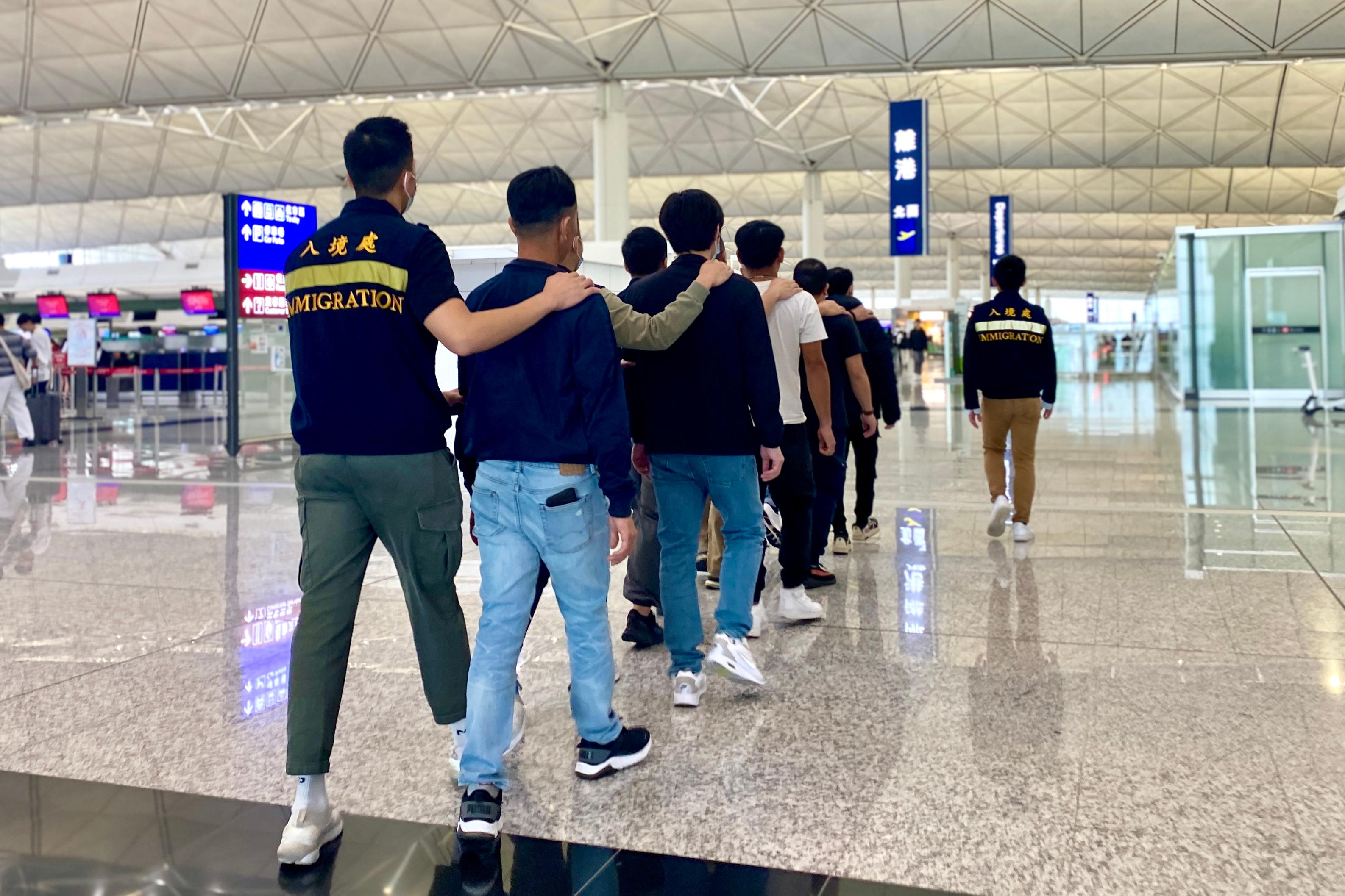 The Immigration Department (ImmD) carried out a repatriation operation today (November 29). A total of 24 Vietnamese illegal immigrants were repatriated to Vietnam. Photo shows removees being escorted by ImmD officers to depart from Hong Kong.