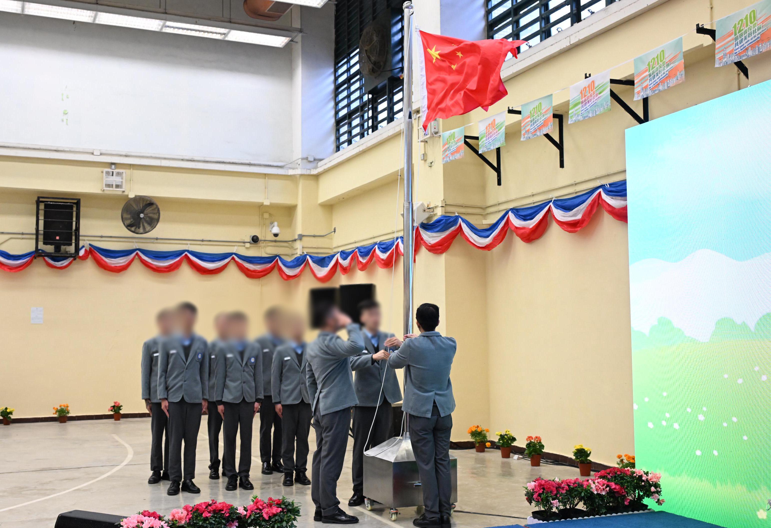 The Correctional Services Department held the opening ceremony of the Ethics College at Pak Sha Wan Correctional Institution today (November 30). Photo shows a flag raising team composed of persons in custody performing a flag raising ceremony.