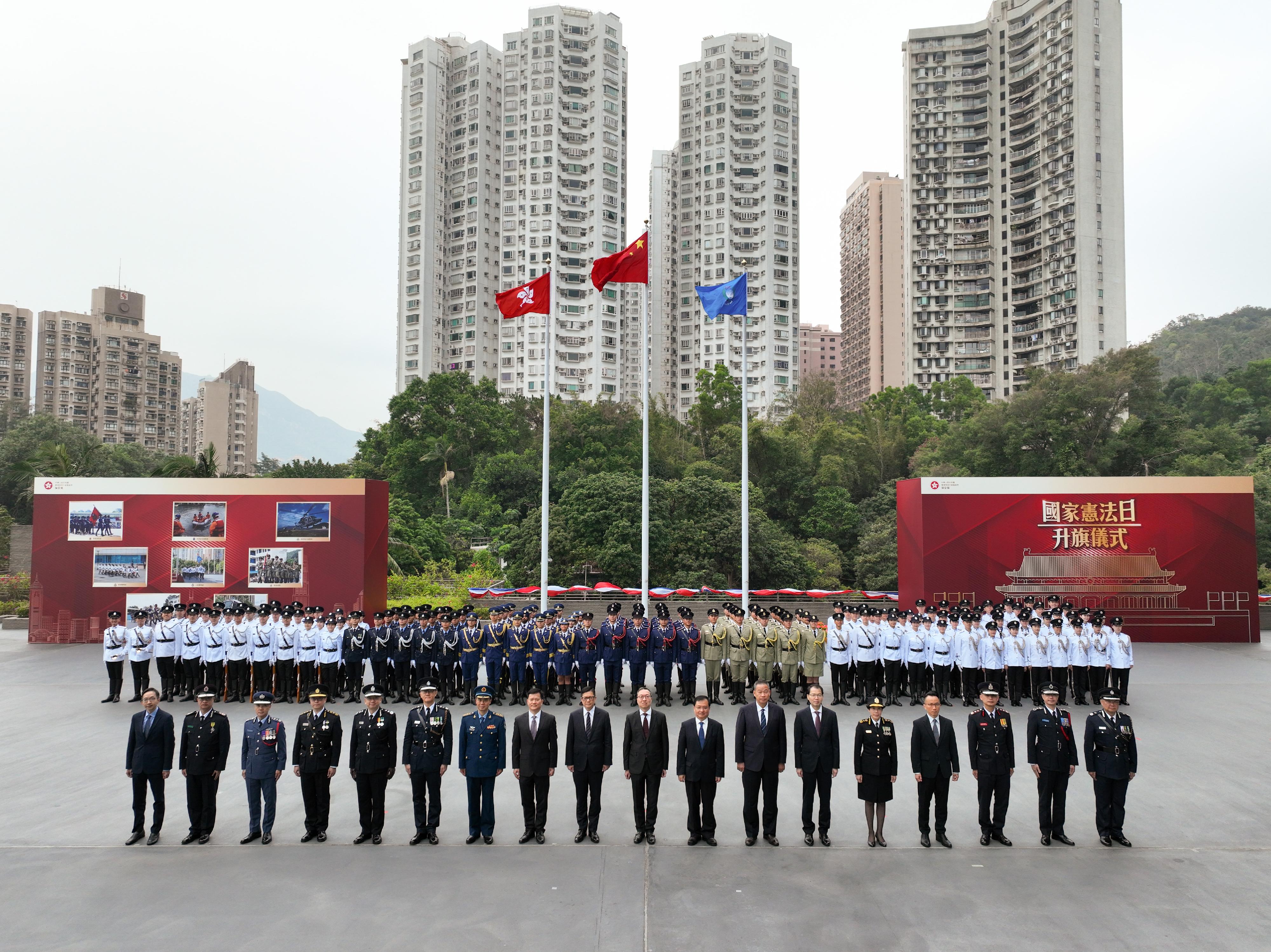 The Security Bureau today (December 4) held the Constitution Day Flag Raising Ceremony. Photo shows (front row, from left) the Deputy Director of Broadcasting, Mr Raymond Sy; the Chief Staff Officer of the Auxiliary Medical Service, Mr Wong Ying-keung; the Controller of the Government Flying Service, Captain West Wu; the Commissioner of Correctional Services, Mr Wong Kwok-hing; the Director of Immigration, Mr Benson Kwok; the Commissioner of Police, Mr Siu Chak-yee; People's Liberation Army Hong Kong Garrison Air Force Senior Colonel Jiang Junde; the Director-General of the Police Liaison Department of the Liaison Office of the Central People's Government in the Hong Kong Special Administrative Region (HKSAR), Mr Chen Feng; the Secretary for Security, Mr Tang Ping-keung; the Secretary for Justice, Mr Paul Lam, SC; Deputy Commissioner of the Office of the Commissioner of the Ministry of Foreign Affairs of the People's Republic of China in the HKSAR Mr Fang Jianming; the Director of the liaison office of the Office for Safeguarding National Security of the Central People's Government in the HKSAR, Mr Deng Jianwei; the Secretary General of the Committee for Safeguarding National Security of the HKSAR, Mr Sonny Au; the Commissioner of Customs and Excise, Ms Louise Ho; the Permanent Secretary for Security, Mr Patrick Li; the Director of Fire Services, Mr Andy Yeung; the Commissioner of the Civil Aid Service, Mr Lo Yan-lai; and the Commandant of the Hong Kong Auxiliary Police Force, Mr Yang Joe-tsi.