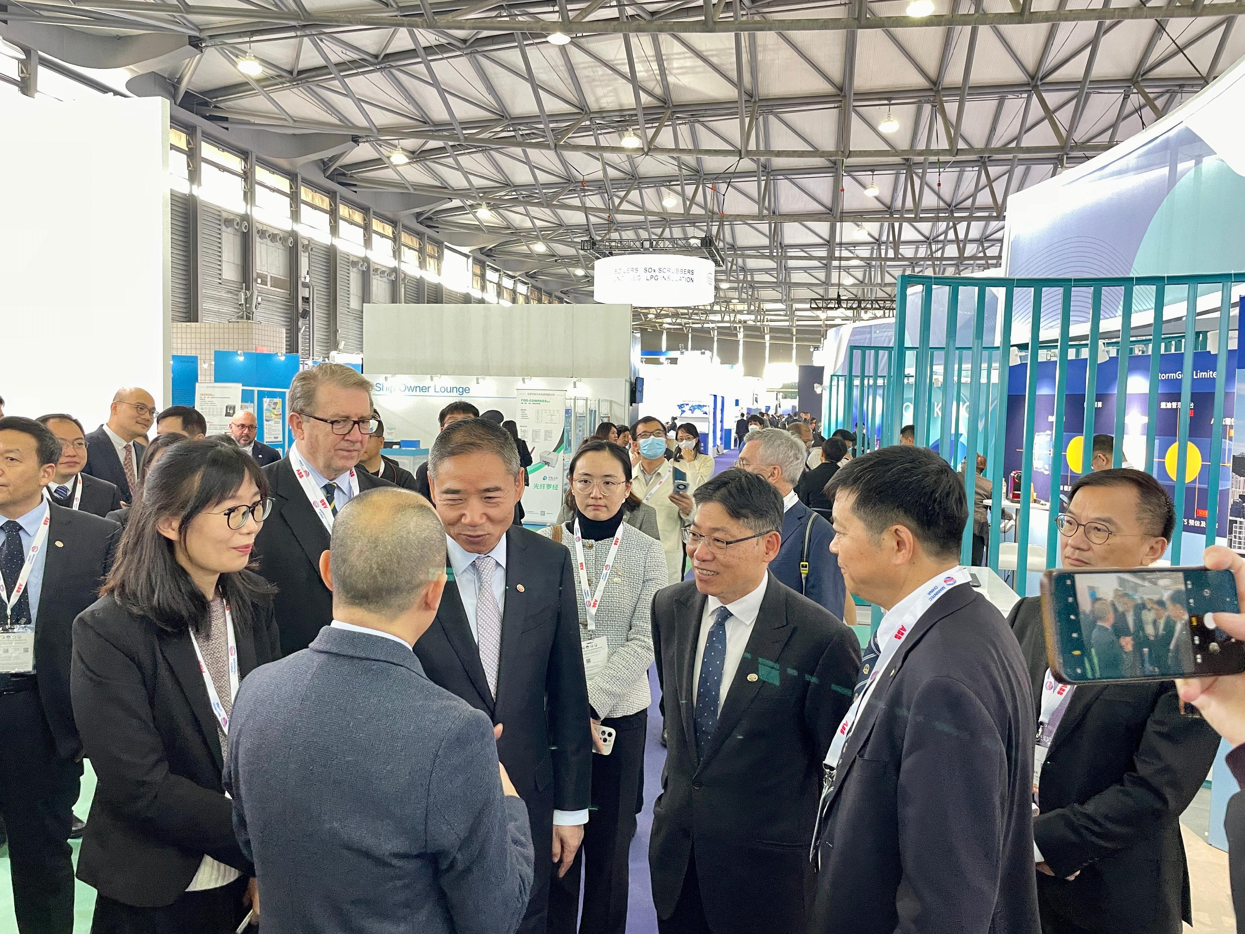The Chairman of the Hong Kong Maritime and Port Board and Secretary for Transport and Logistics, Mr Lam Sai-hung (third right), is briefed on the Hong Kong Shipping Register with Vice Minister of the Ministry of Industry and Information Technology Mr Xin Guobin (fourth right) at the China Hong Kong Pavilion, part of the Marintec China 2023, in Shanghai today (December 5).