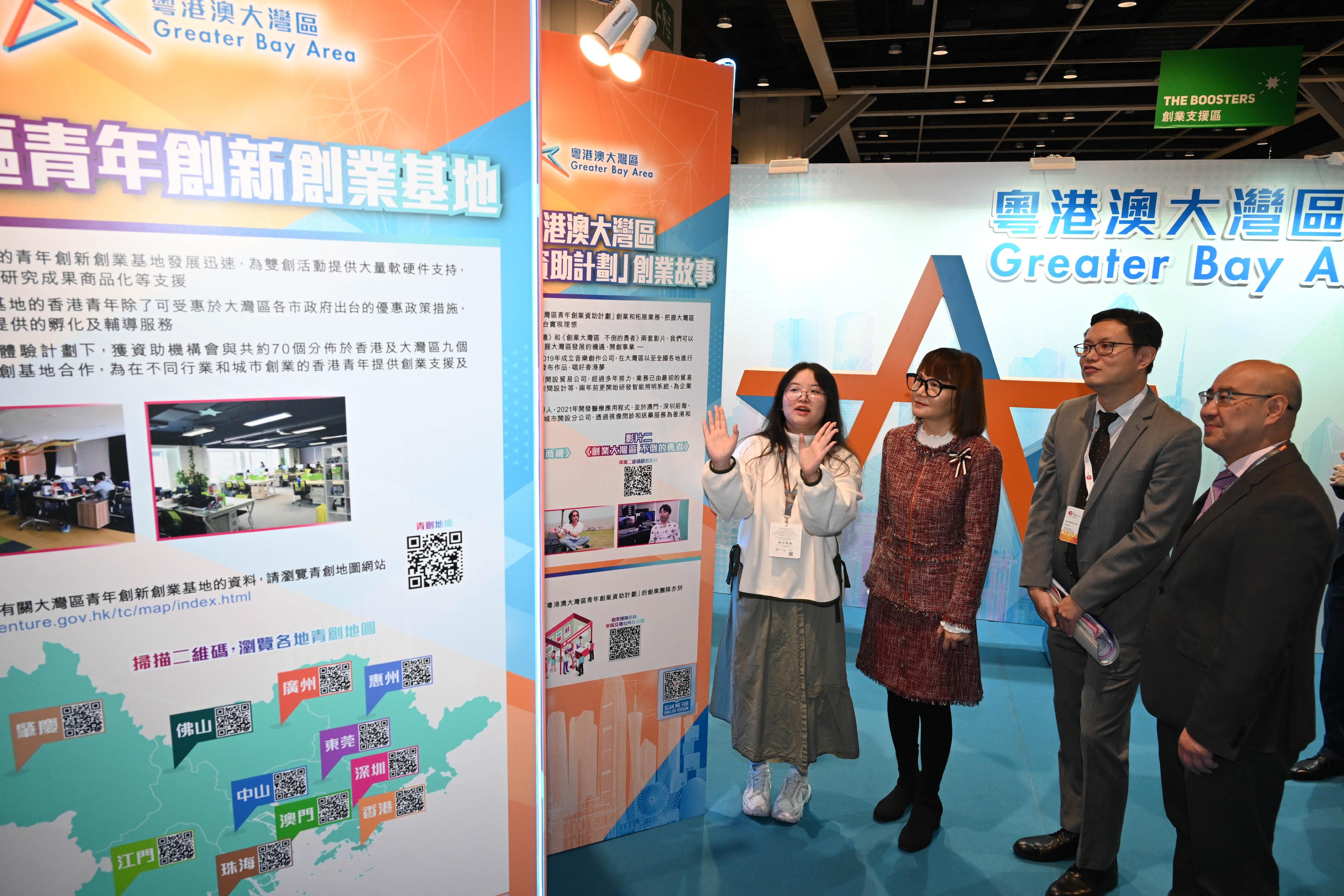 The Commissioner for the Development of the Guangdong-Hong Kong-Macao Greater Bay Area, Ms Maisie Chan (second left), visits the Guangdong-Hong Kong-Macao Greater Bay Area Development Office's exhibition booth at the Entrepreneur Day exhibition today (December 7).