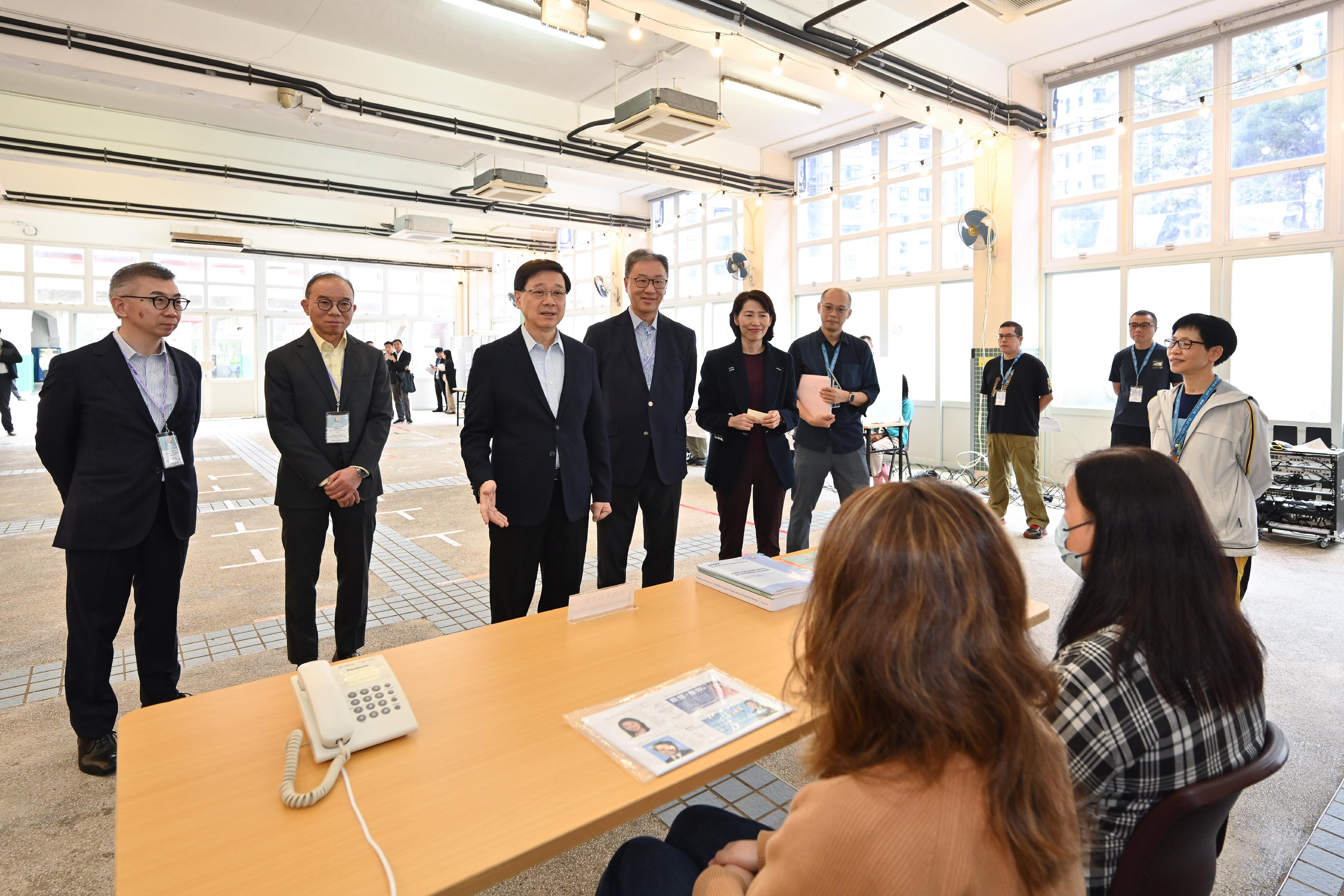 The Chairman of the Electoral Affairs Commission, Mr Justice David Lok (fourth left), and the Secretary for Constitutional and Mainland Affairs, Mr Erick Tsang Kwok-wai (second left), accompanied the Chief Executive, Mr John Lee (third left), to inspect the District Council geographical constituency polling station of the 2023 District Council Ordinary Election at Lingnan Secondary School this morning (December 9) and show support to the electoral staff. Also present were the Director of the Chief Executive's Office, Ms Carol Yip (fifth left), and the Chief Electoral Officer of the Registration and Electoral Office, Mr Raymond Wang (first left).