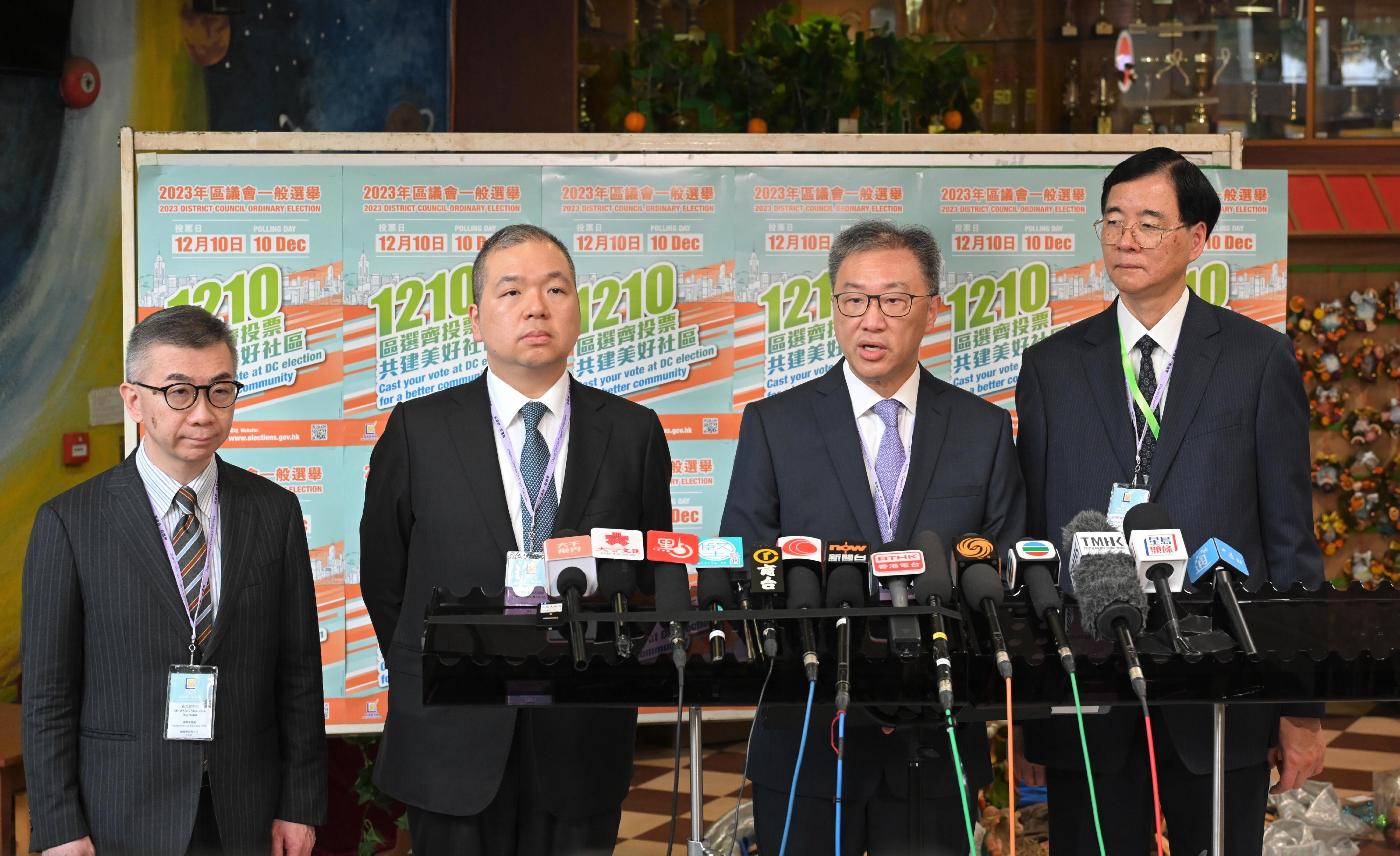 The Chairman of the Electoral Affairs Commission (EAC), Mr Justice David Lok (second right), EAC members Professor Daniel Shek (first right) and Mr Bernard Man, SC (third right), meet the media after inspecting the District Council geographical constituency polling station of the 2023 District Council Ordinary Election at the Yaumati Catholic Primary School (Hoi Wang Road) this morning (December 10). Also present is the Chief Electoral Officer of the Registration and Electoral Office, Mr Raymond Wang (fourth right).