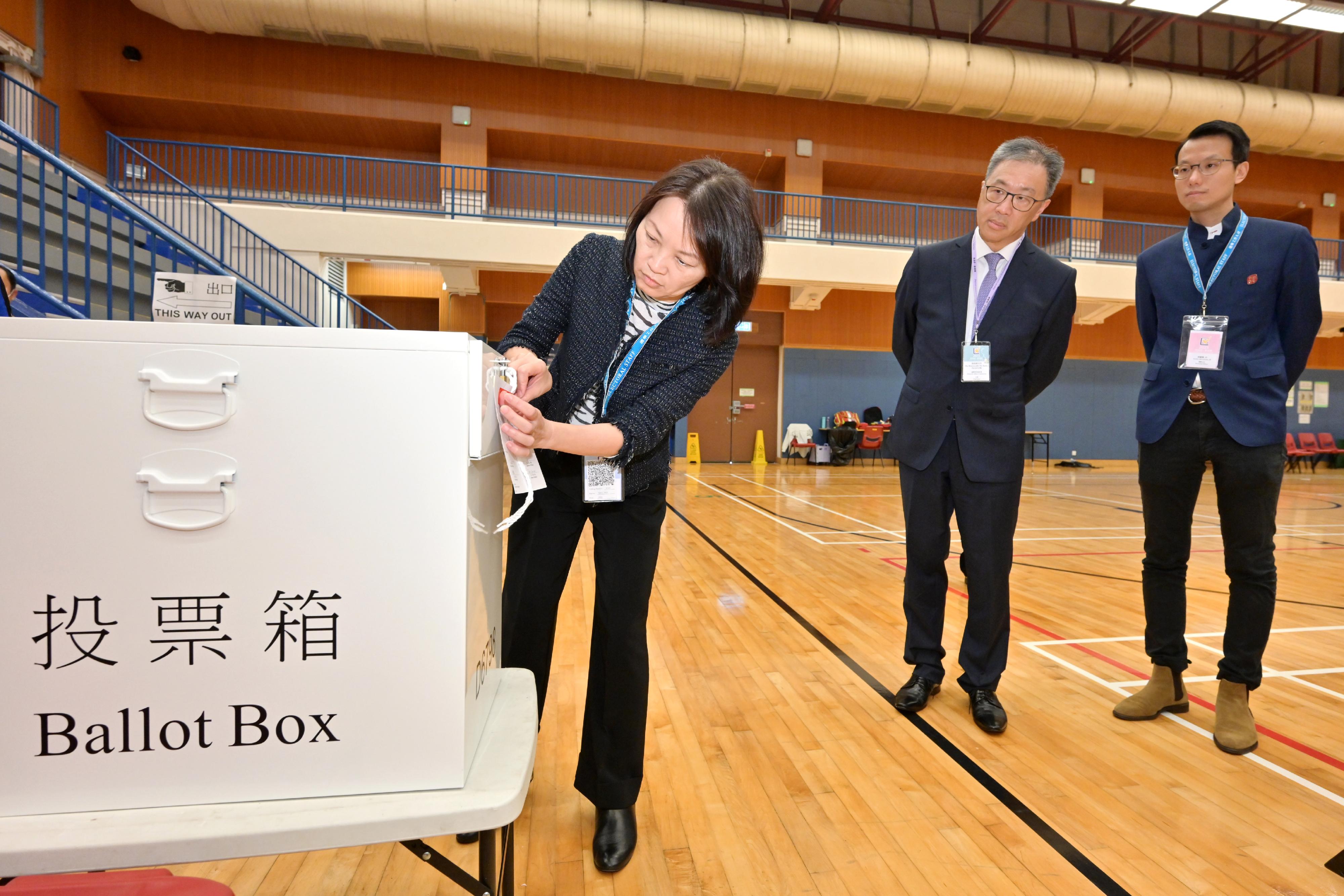The Chairman of the Electoral Affairs Commission, Mr Justice David Lok (centre), visits the District Committees constituency polling station of the 2023 District Council Ordinary Election at Osman Ramju Sadick Memorial Sports Centre this afternoon (December 10) to inspect the presiding officer locking and sealing the ballot box.