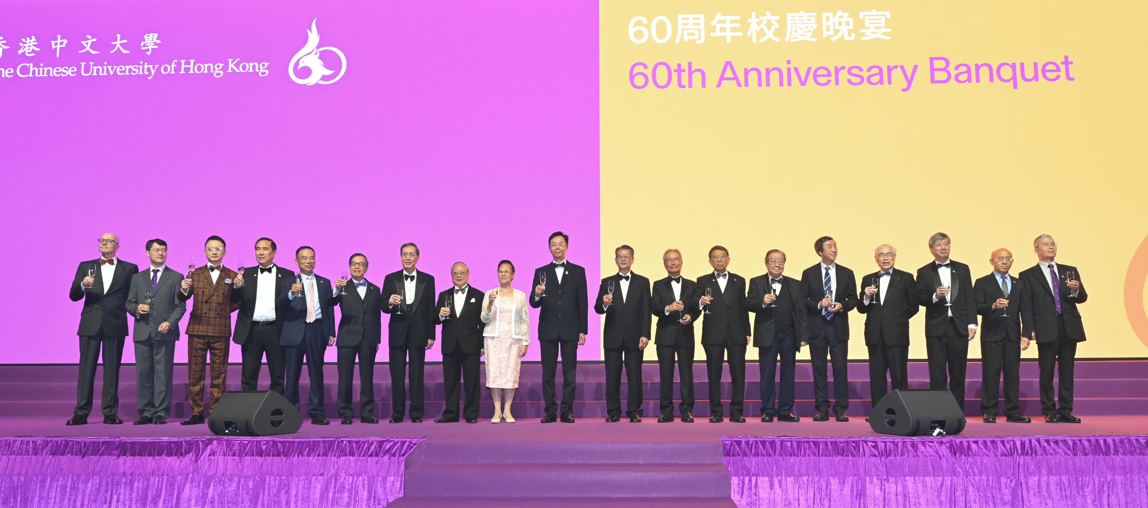 The Financial Secretary, Mr Paul Chan, attends at the Chinese University of Hong Kong 60th Anniversary Banquet today (December 10). Photo shows Mr Chan (ninth right) in a toast with other officiating guests. 