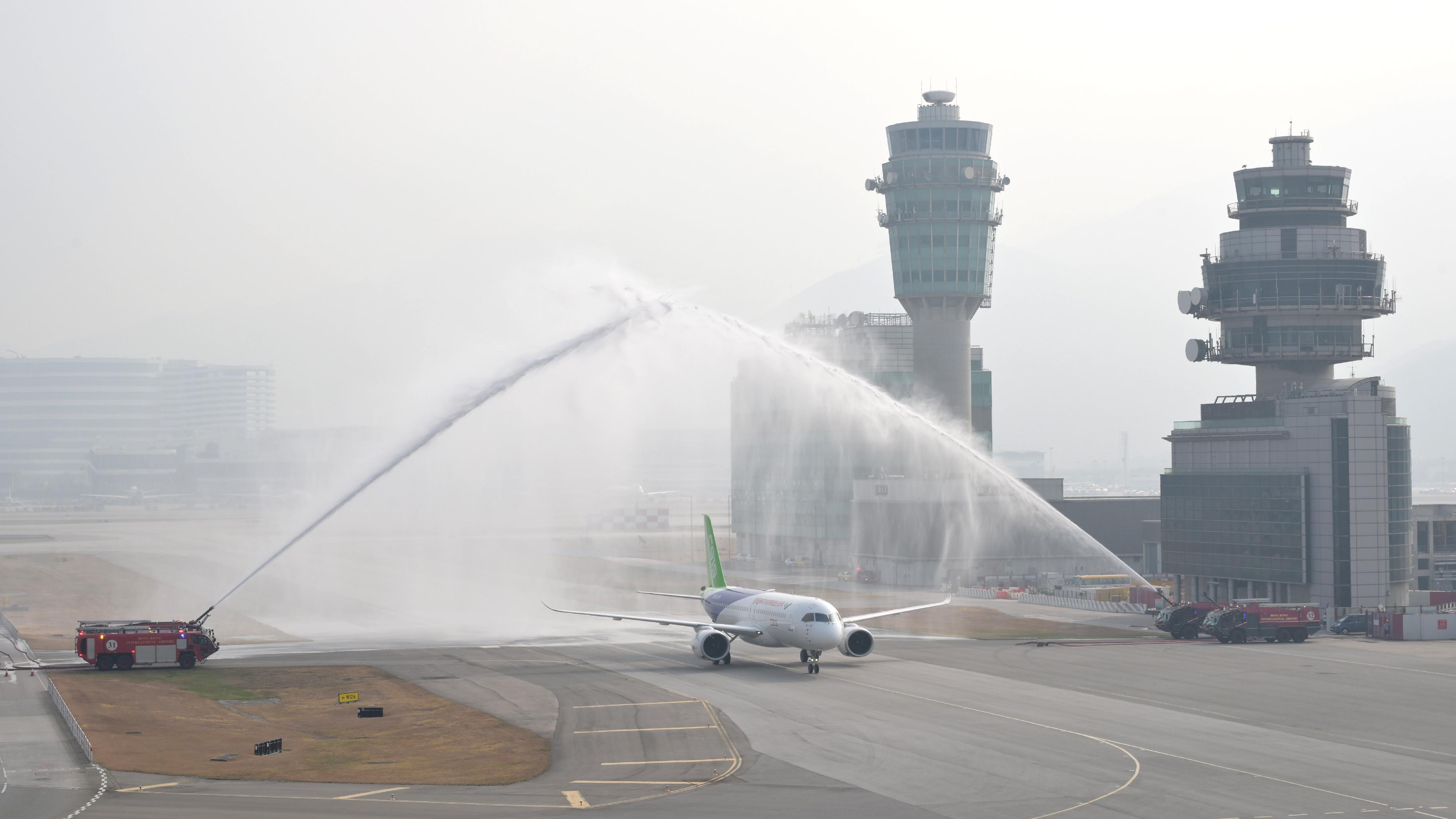 Home-developed aircraft C919 and ARJ21 launched inaugural flights to Hong Kong today (December 12). Photo shows the C919 aircraft being welcomed by a ceremonial water salute upon its arrival at Hong Kong International Airport.	


