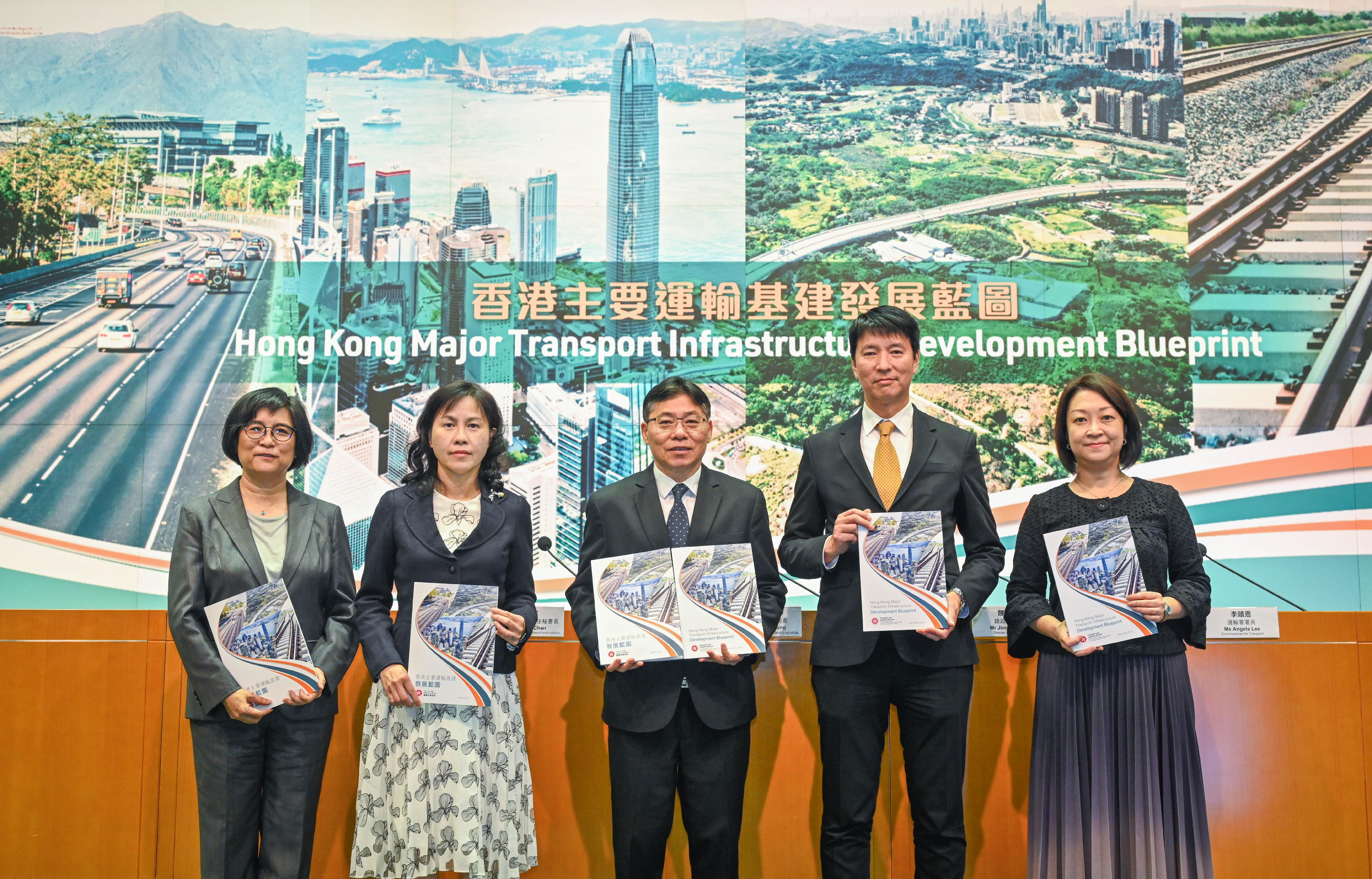 The Secretary for Transport and Logistics, Mr Lam Sai-hung, promulgated today (December 12) the Hong Kong Major Transport Infrastructure Development Blueprint to outline a forward-looking vision for strategic railway and major road networks, with a view to meeting Hong Kong's long-term transport and logistics demand up to 2046 and beyond. Photo shows Mr Lam (centre); the Permanent Secretary for Transport and Logistics, Ms Mable Chan (second left); the Director of Highways, Mr Jimmy Chan (second right); the Commissioner for Transport, Ms Angela Lee (first right); and Deputy Secretary for Transport and Logistics Ms Amy Wong (first left) at the press conference.