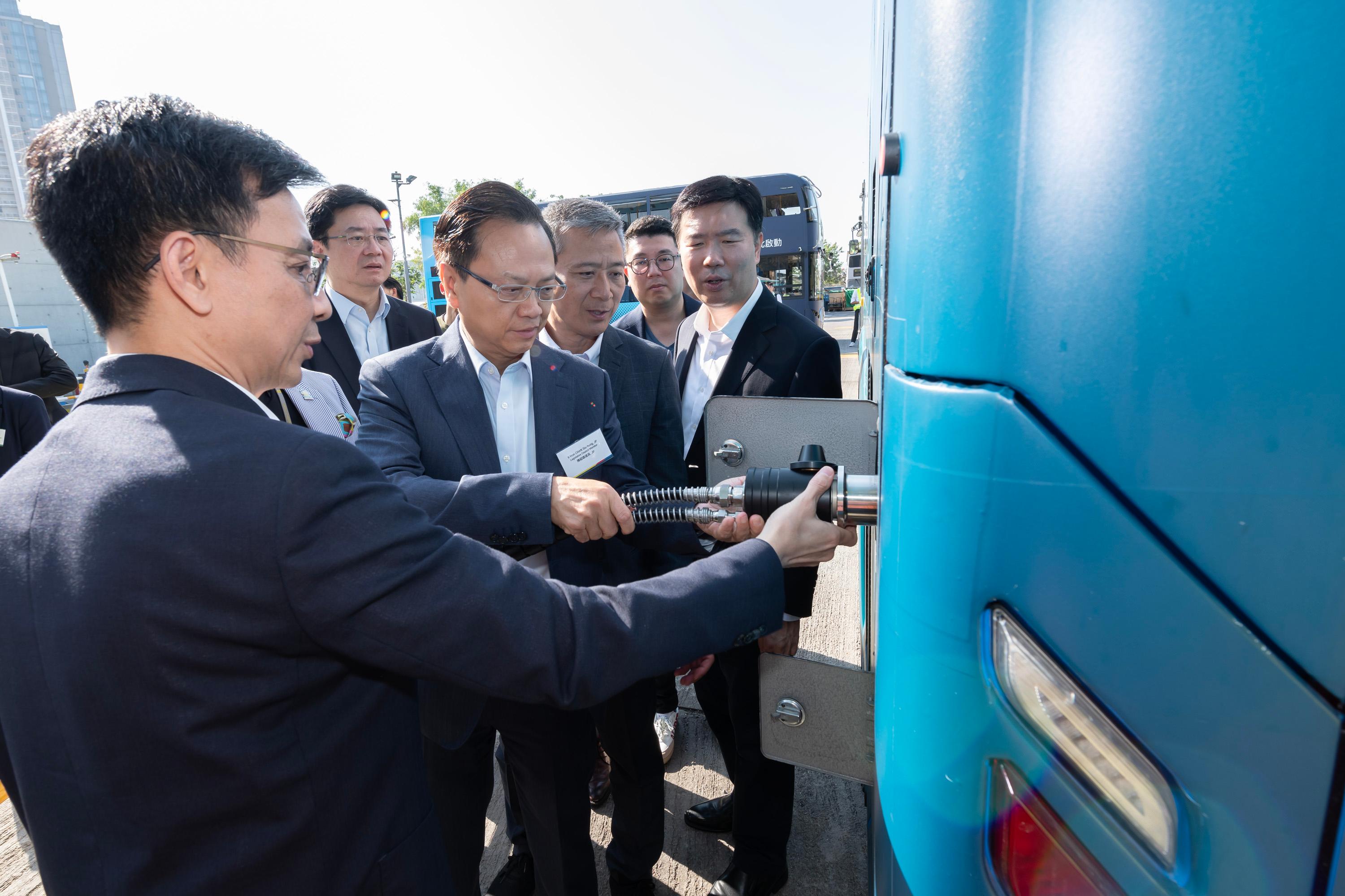 The Legislative Council Panel on Environmental Affairs and Panel on Transport conducted a joint visit to the Citybus Hydrogen Refuelling Station and its hydrogen bus today (December 12). Photo shows the Deputy Chairman of the Panel on Transport, Mr Chan Siu-hung (second left), and other Members learning about the environmental friendliness of the hydrogen bus.