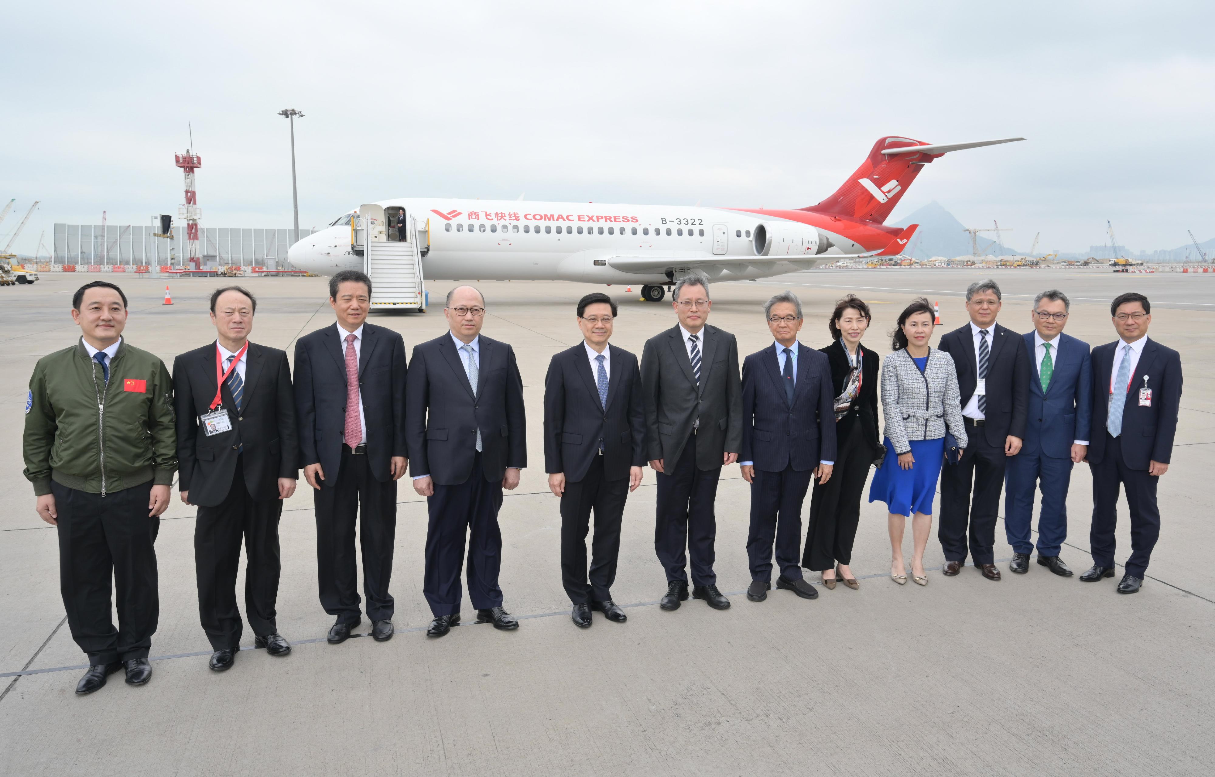 The Chief Executive, Mr John Lee, attended the welcome ceremony for aircraft C919 and ARJ21 today (December 13). Photo shows Mr Lee (fifth left); the Director of the Liaison Office of the Central People's Government in the Hong Kong Special Administrative Region, Mr Zheng Yanxiong (fourth left); Deputy Administrator of the Civil Aviation Administration of China Mr Cui Xiaofeng (third left); the Chairman of the Airport Authority Hong Kong, Mr Jack So (sixth right); Vice President of Commercial Aircraft Corporation of China, Ltd Mr Zhang Yujin (sixth left), and other guests pictured in front of aircraft ARJ21.