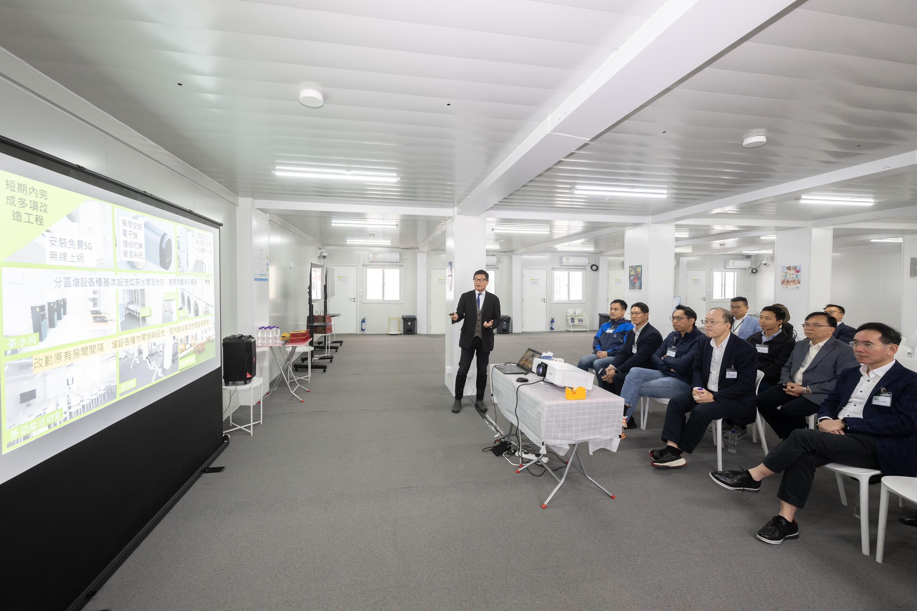 The Legislative Council Panel on Manpower visited the Construction Sector Imported Labour Quarters in Tam Mi, Yuen Long, today (December 19). Photo shows Members receiving a briefing on the overview of the Quarters by the Executive Director of the Construction Industry Council, Mr Albert Cheng.