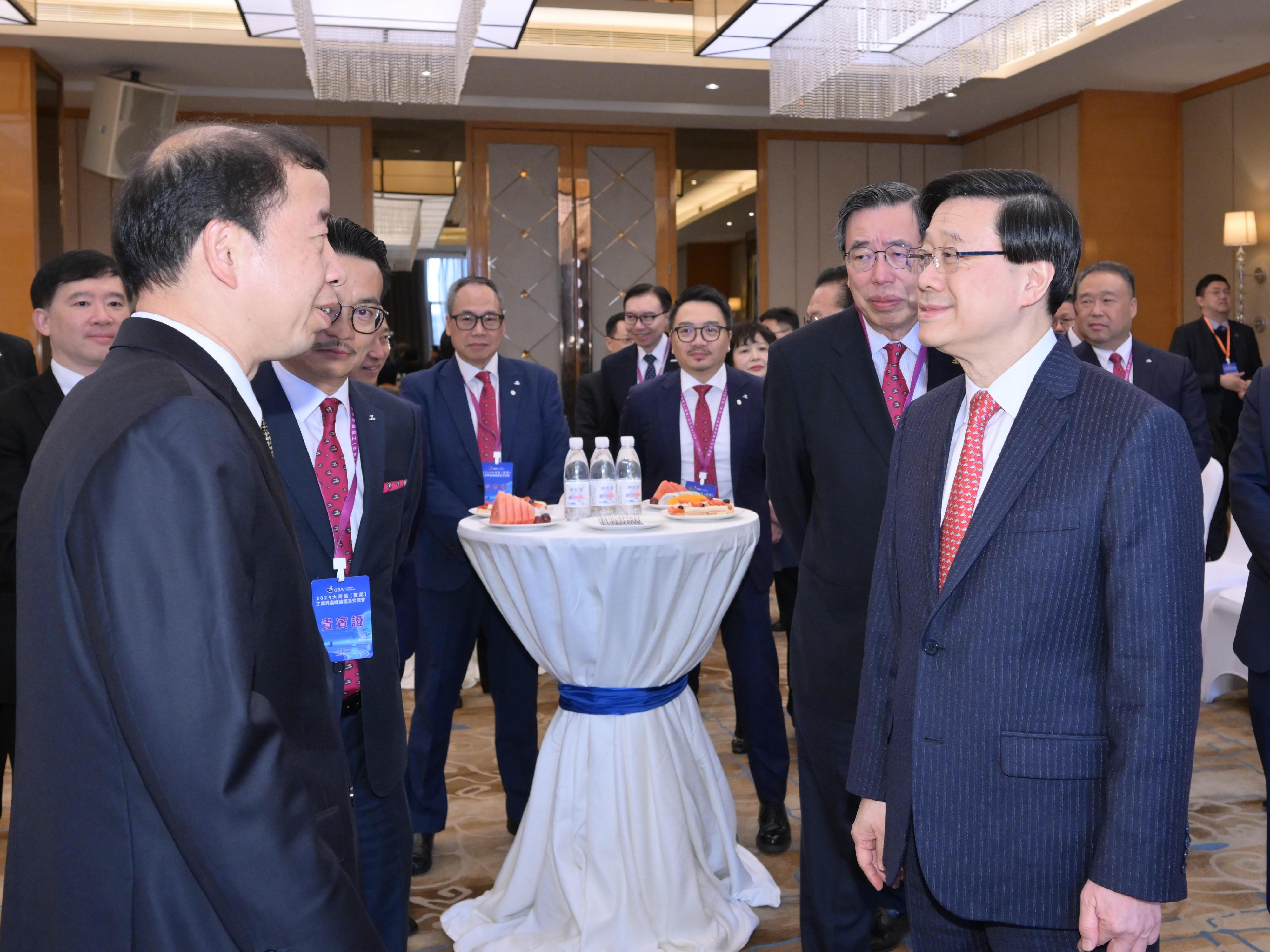 The Chief Executive, Mr John Lee, attended the 2024 GBA iForum hosted by the Federation of Hong Kong Industries in Dongguan today (January 4). Photo shows Mr Lee (first right); the Vice-Chairman of the Standing Committee of the Guangdong Provincial People's Congress and the Secretary of the CPC Dongguan Municipal Committee, Mr Xiao Yafei (first left), interacting with other guests.
