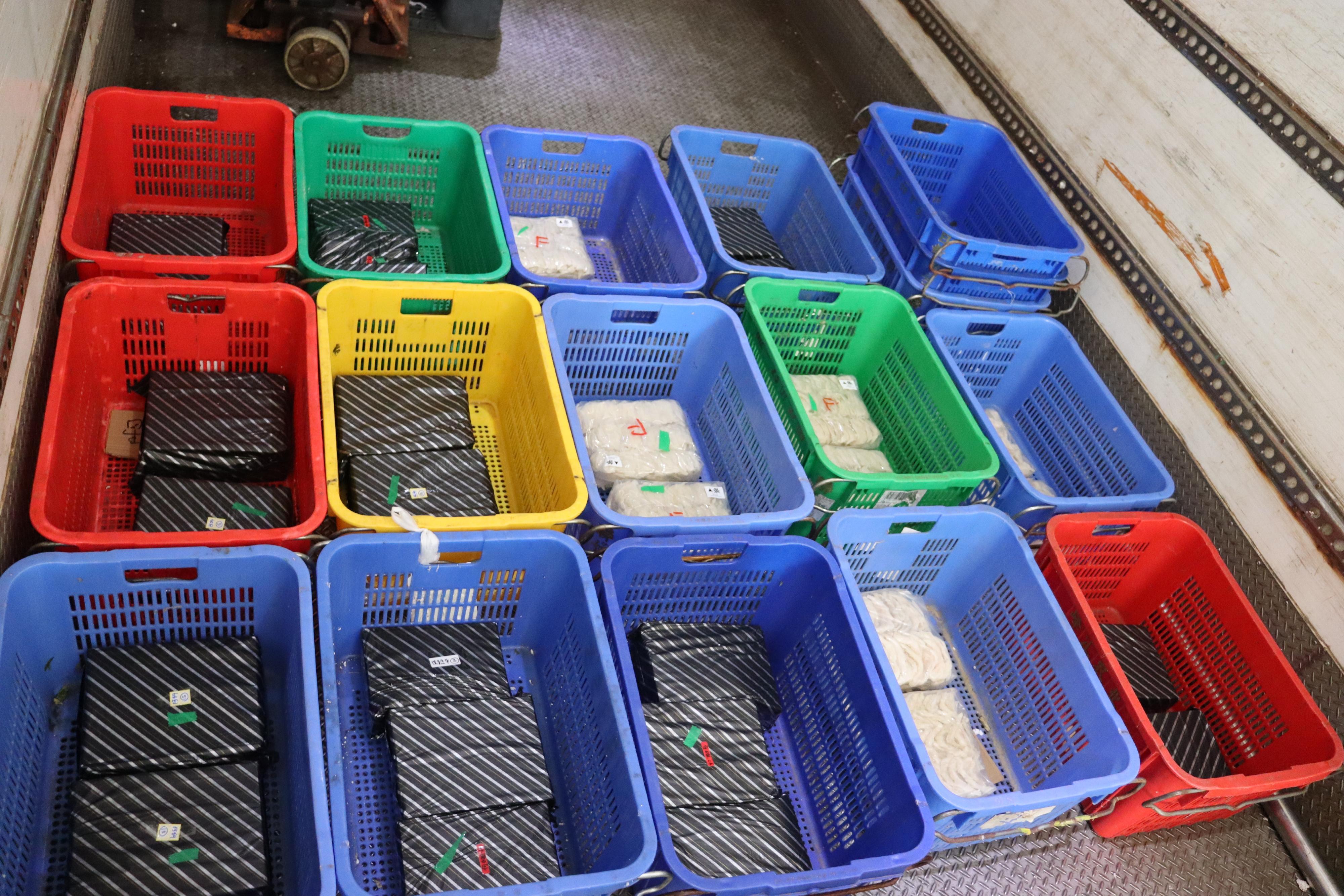 Hong Kong Customs yesterday (January 3) detected a suspected smuggling case involving a cross-boundary goods vehicle at the Man Kam To Control Point and seized about 234 kilograms of suspected smuggled bird's nests with an estimated market value of about $9.5 million. Photo shows some of the suspected smuggled bird's nests seized in between stacks of plastic baskets.
