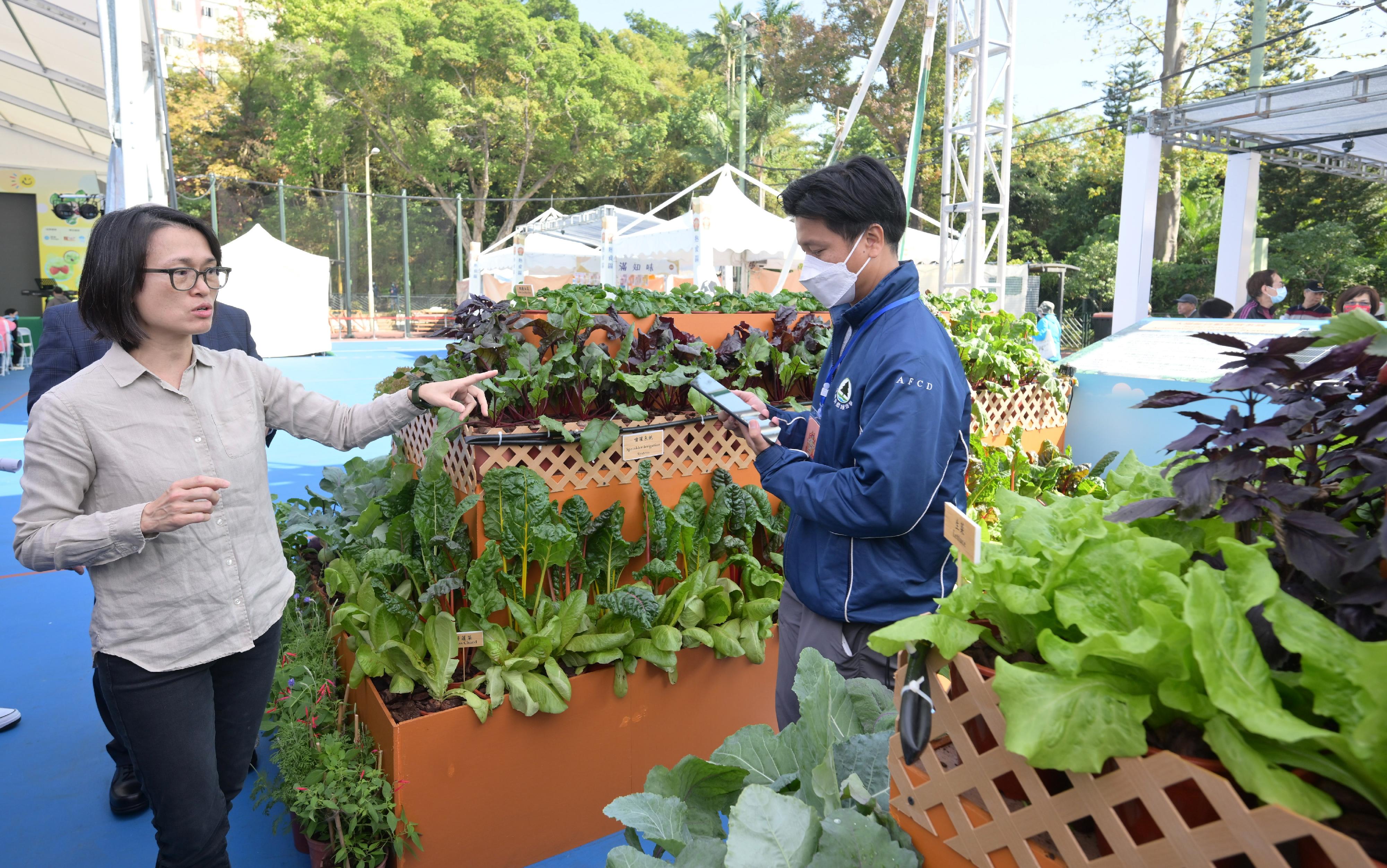 2024本地漁農美食嘉年華由今日（一月五日）至一月七日，一連三天在旺角花墟公園舉行，展銷多種本地漁農產品及其他貨品。圖示漁農自然護理署農業主任（園藝）王敏維介紹農展區的太陽能自動灌溉系統。



