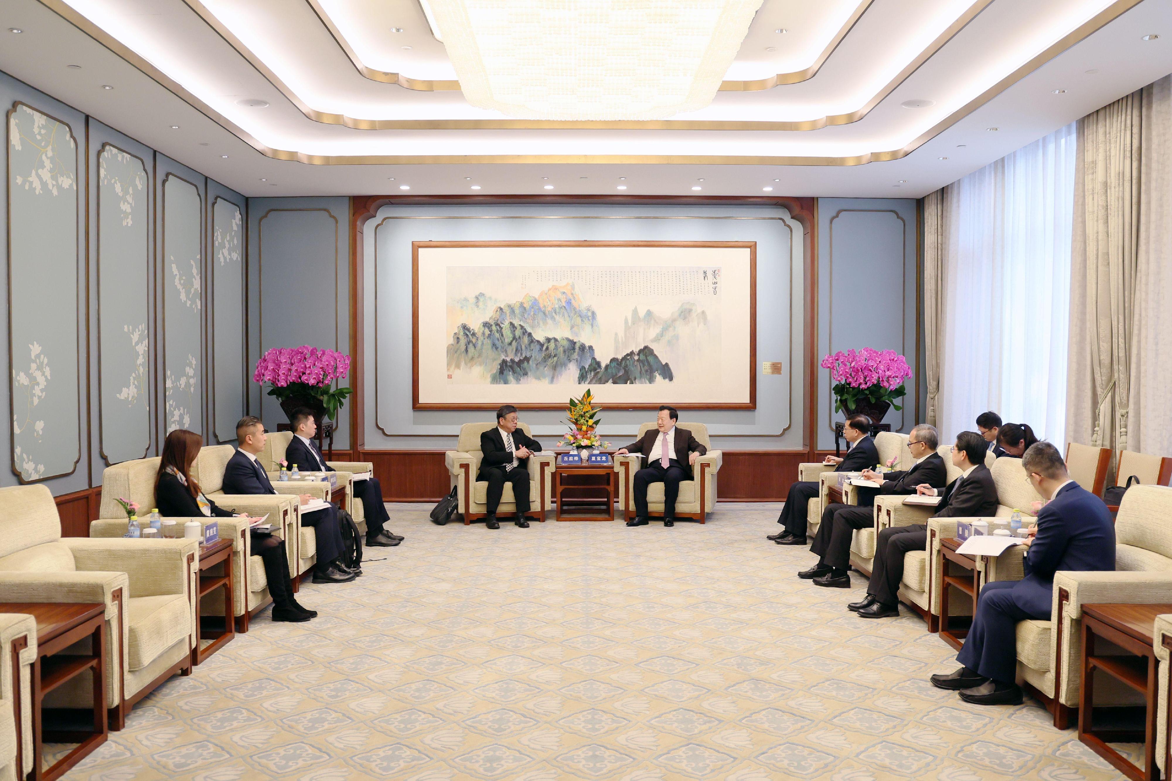 The Secretary for Commerce and Economic Development, Mr Algernon Yau, began his visit programme to Beijing today (January 10). Photo shows Mr Yau (fourth left) calling on the Director of the Hong Kong and Macao Affairs Office of the State Council, Mr Xia Baolong (fifth left).