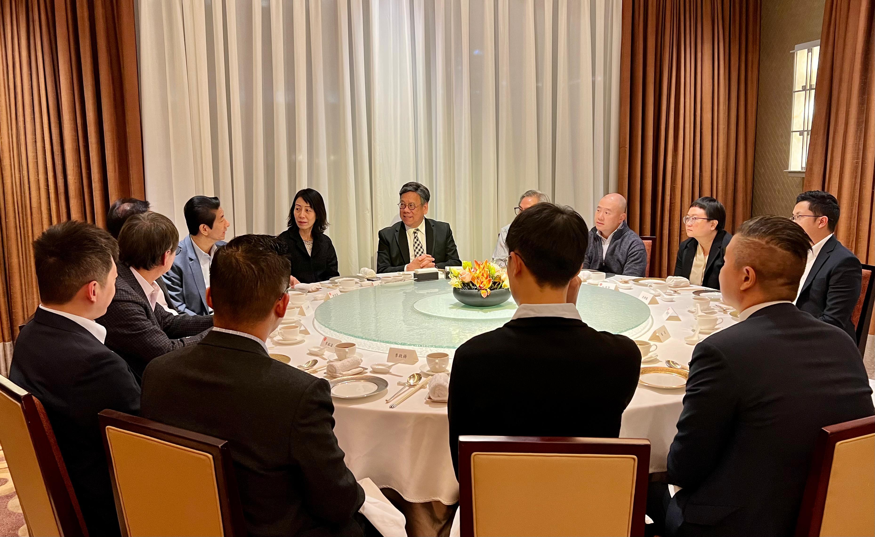 The Secretary for Commerce and Economic Development, Mr Algernon Yau, began his visit programme to Beijing today (January 10). Photo shows Mr Yau (third left) at a dinner with Hong Kong residents and businessmen living in Beijing to understand their developments on the Mainland. Also present is the Director of the Office of the Government of the Hong Kong Special Administrative Region in Beijing, Mr Rex Chang (first left).