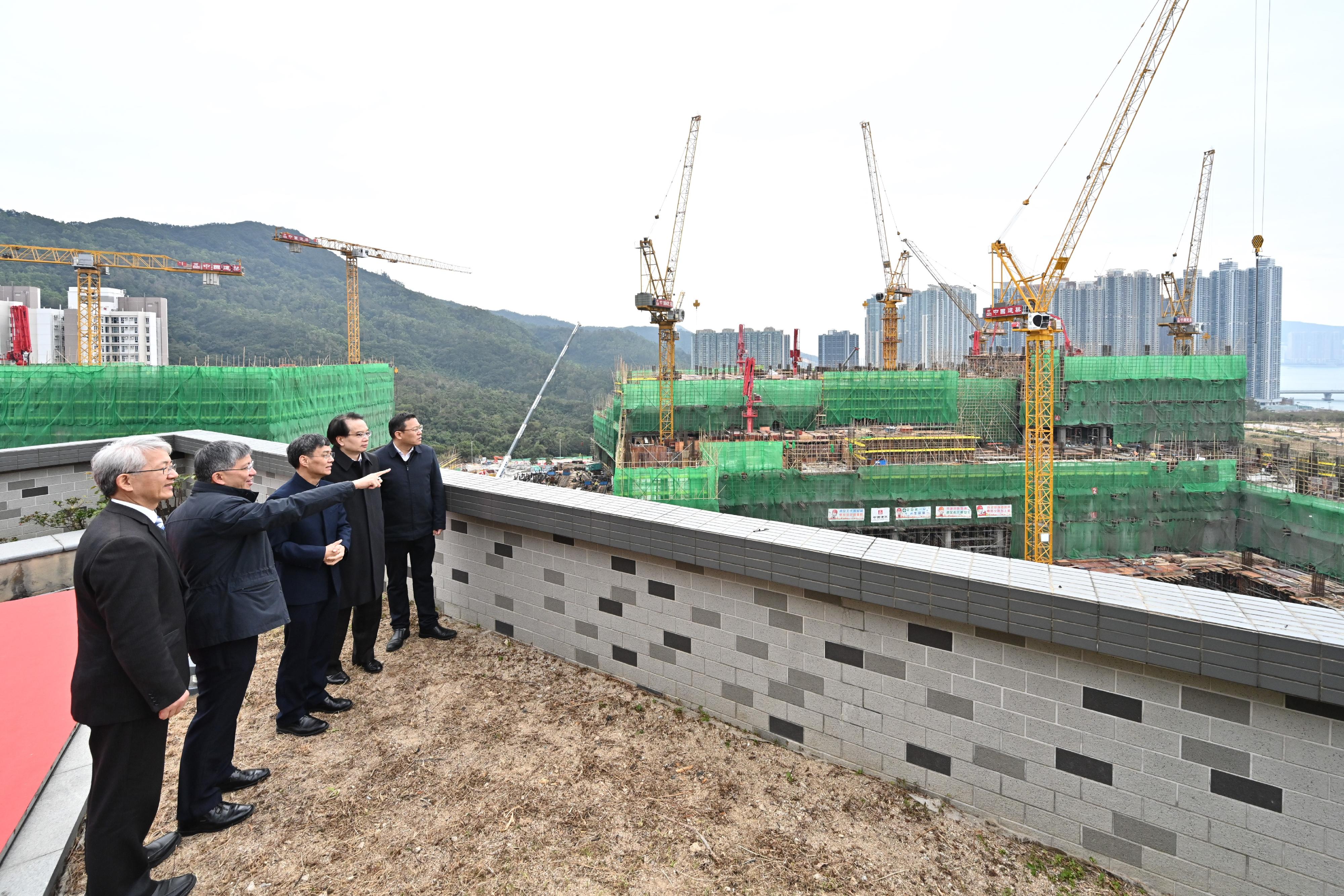 The Permanent Secretary for Health, Mr Thomas Chan (second left), and the President of the Guangdong Provincial Hospital of Traditional Chinese Medicine, Professor Zhang Zhongde (centre), have an overview of the construction site of the Chinese Medicine Hospital of Hong Kong at Pak Shing Kok, Tseung Kwan O, today (January 24) to get a better grasp of the architectural design concept and works progress. Next to them is the Project Director of the Chinese Medicine Hospital Project Office, Dr Cheung Wai-lun (second right).